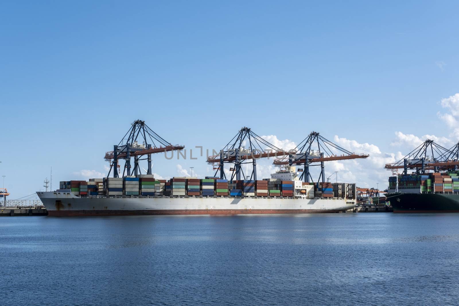 Logistics and transportation of Container Cargo ship and Cargo plane with working crane bridge in shipyard, logistic import export and transport industry background