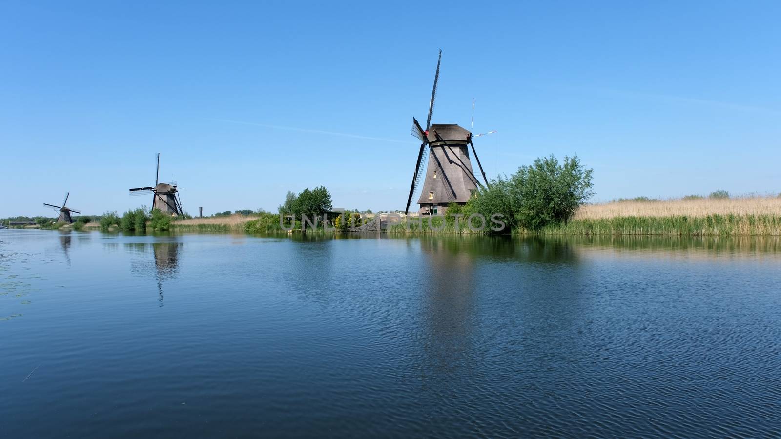 Windmills and water canal in Kinderdijk, Holland or Netherlands. Unesco world heritage site. Europe.