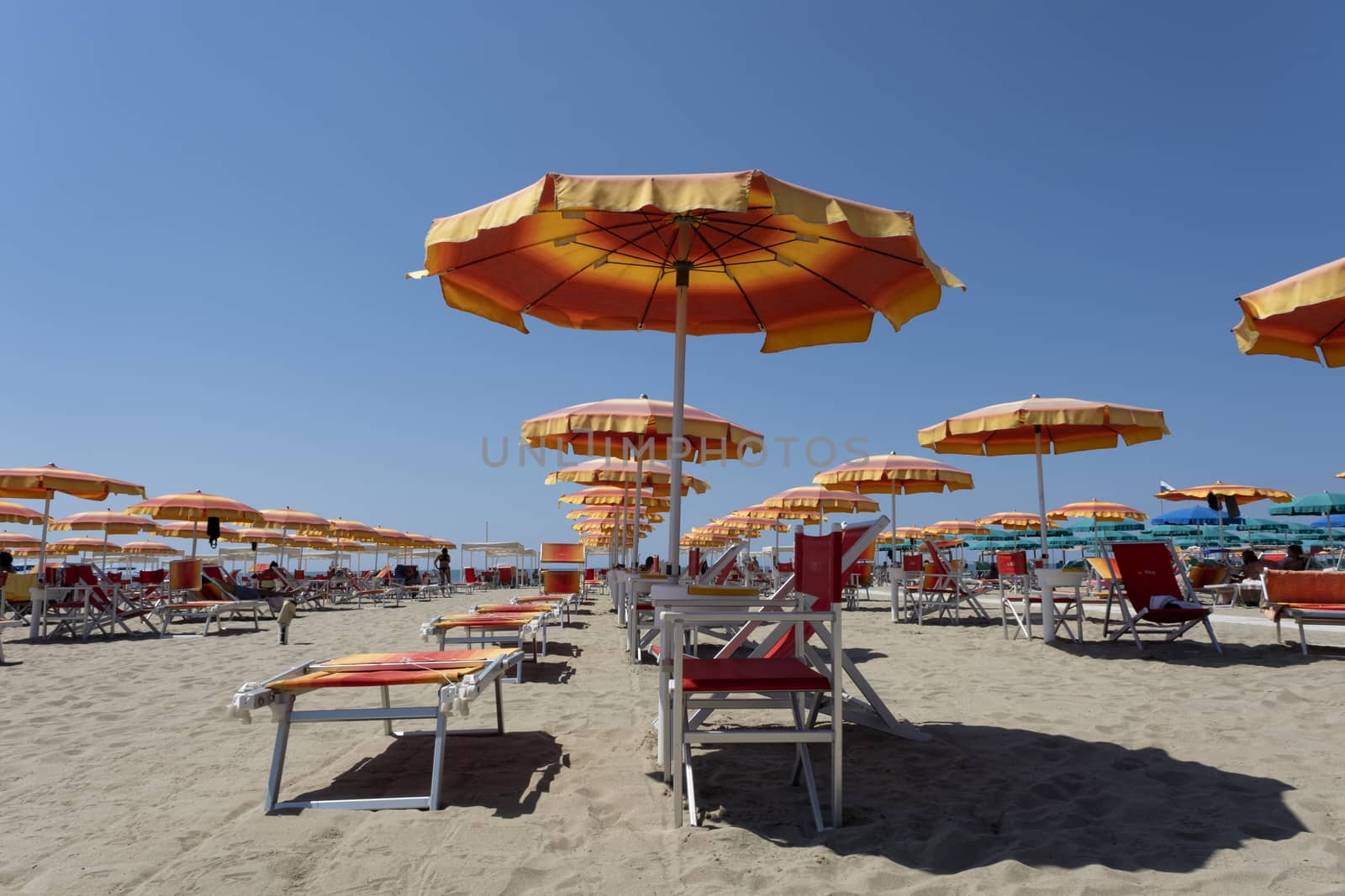 Summer beach landscape with umbrellas and beach chairs by Tjeerdkruse