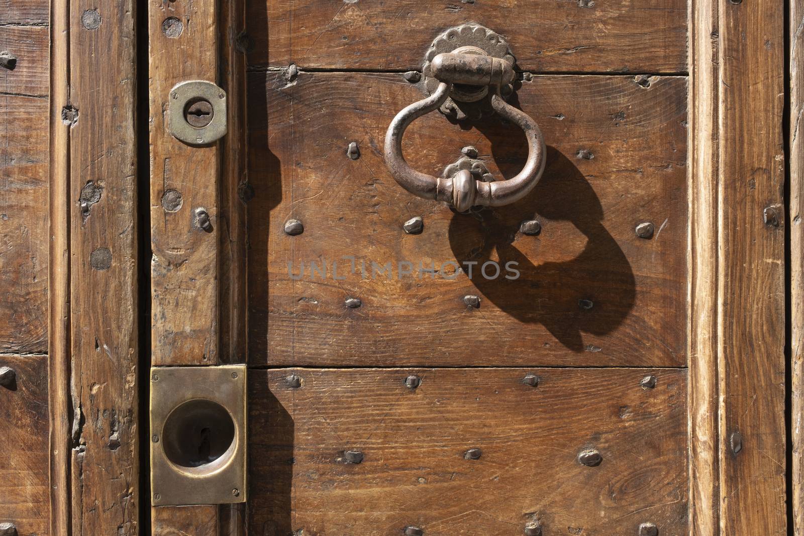 Vintage image of ancient door knocker on a wooden door. by Tjeerdkruse