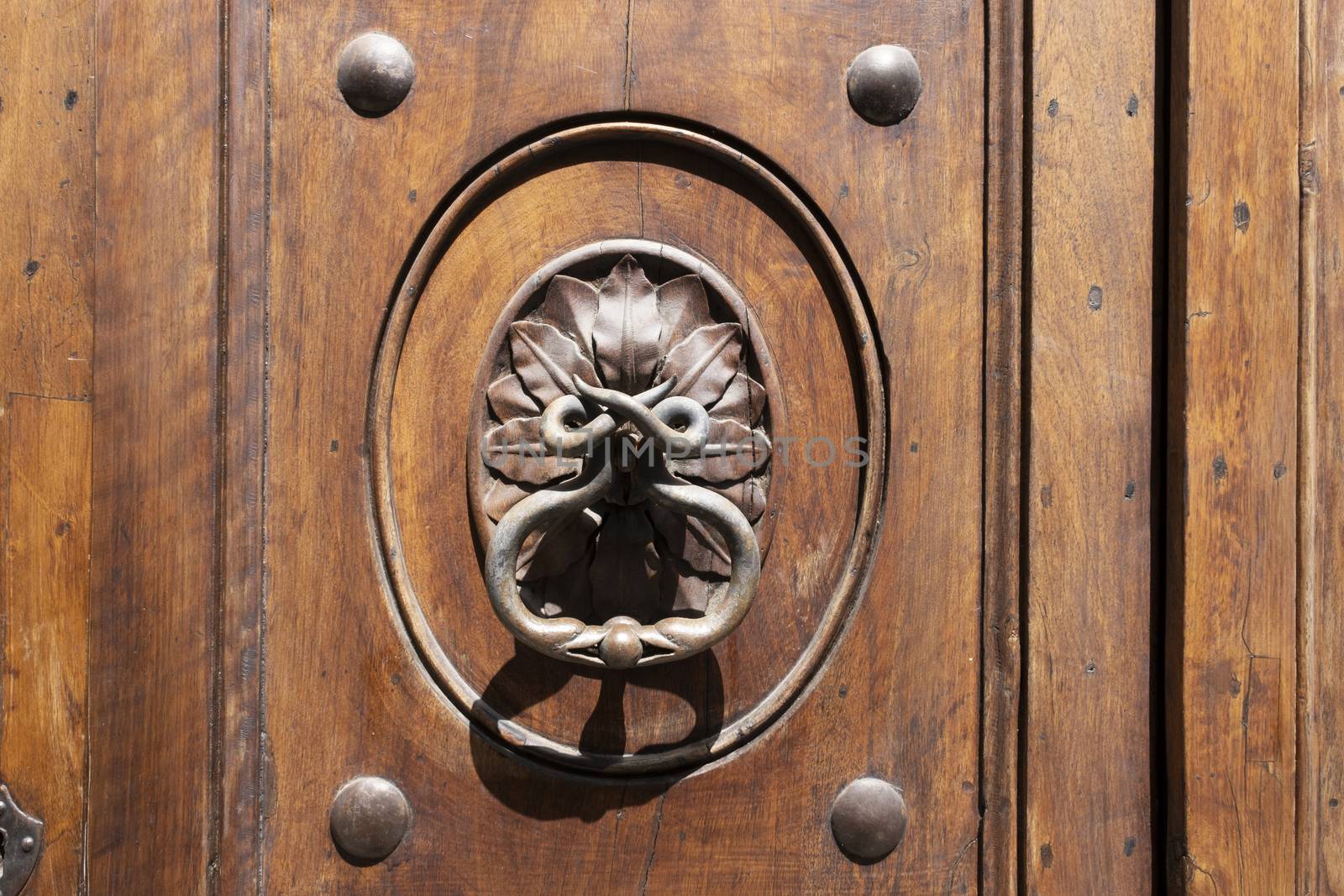 Vintage image of ancient door knocker on a wooden door. by Tjeerdkruse