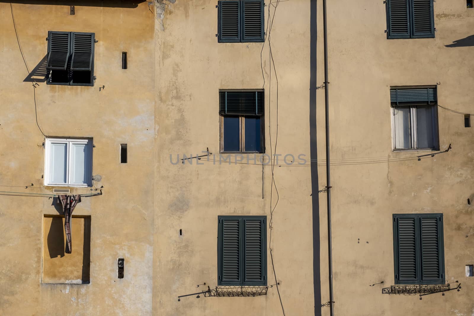 Facade of a Old Building with Windows in a Medieval Town of Tuscany by Tjeerdkruse