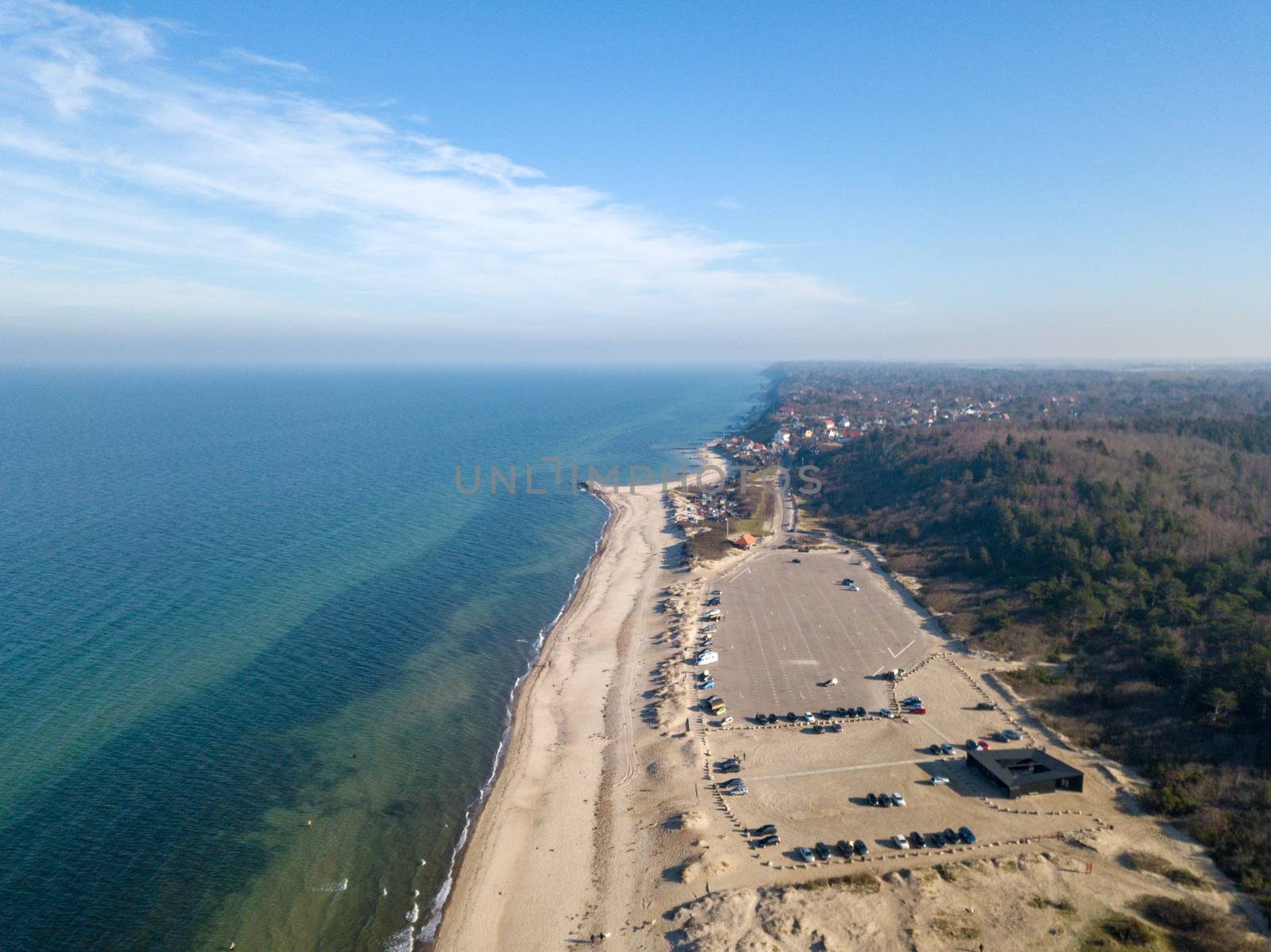 Tisvildeleje, Denmark - February 24, 2019: Aerial drone  view of the coastline with the public parking lot at the beach.