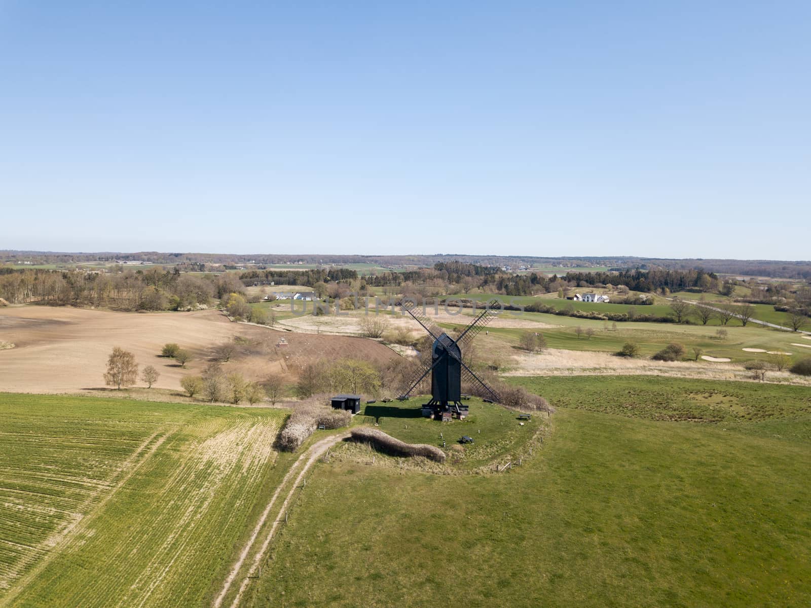 Hoejerg, Denmark - April 23, 2019: Aerial view of the historic Danish windmill called Pibe Moelle.