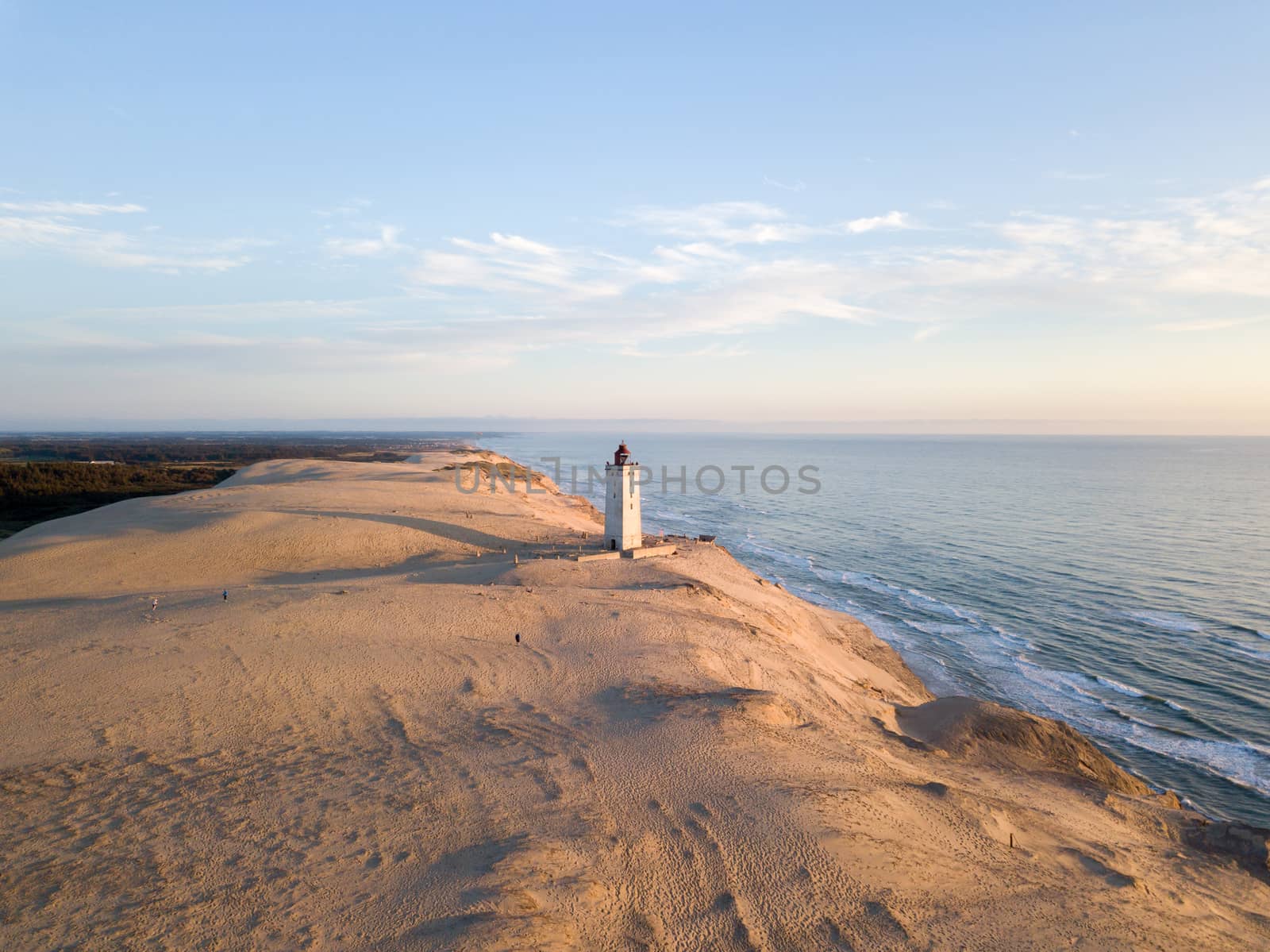 Lokken, Denmark - July 15, 2019: Aerial drone view of Rubjerg Knude Lighthouse and sand dunes.