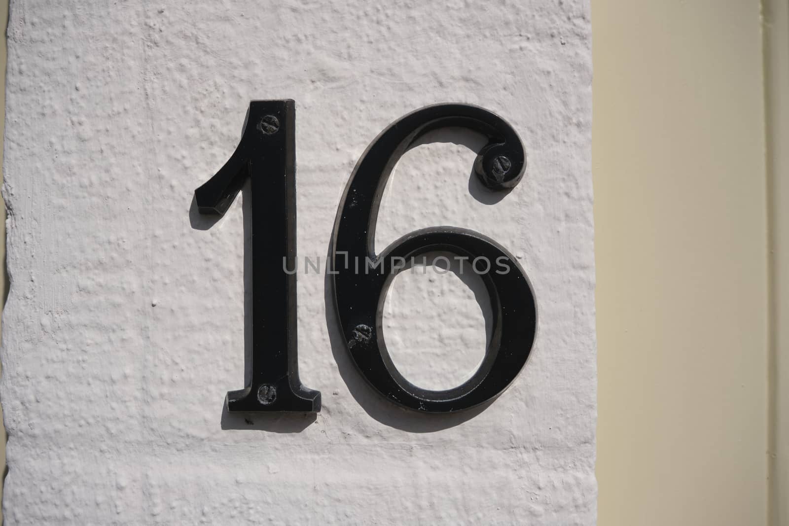 House Number 16 sign on wall by Tjeerdkruse