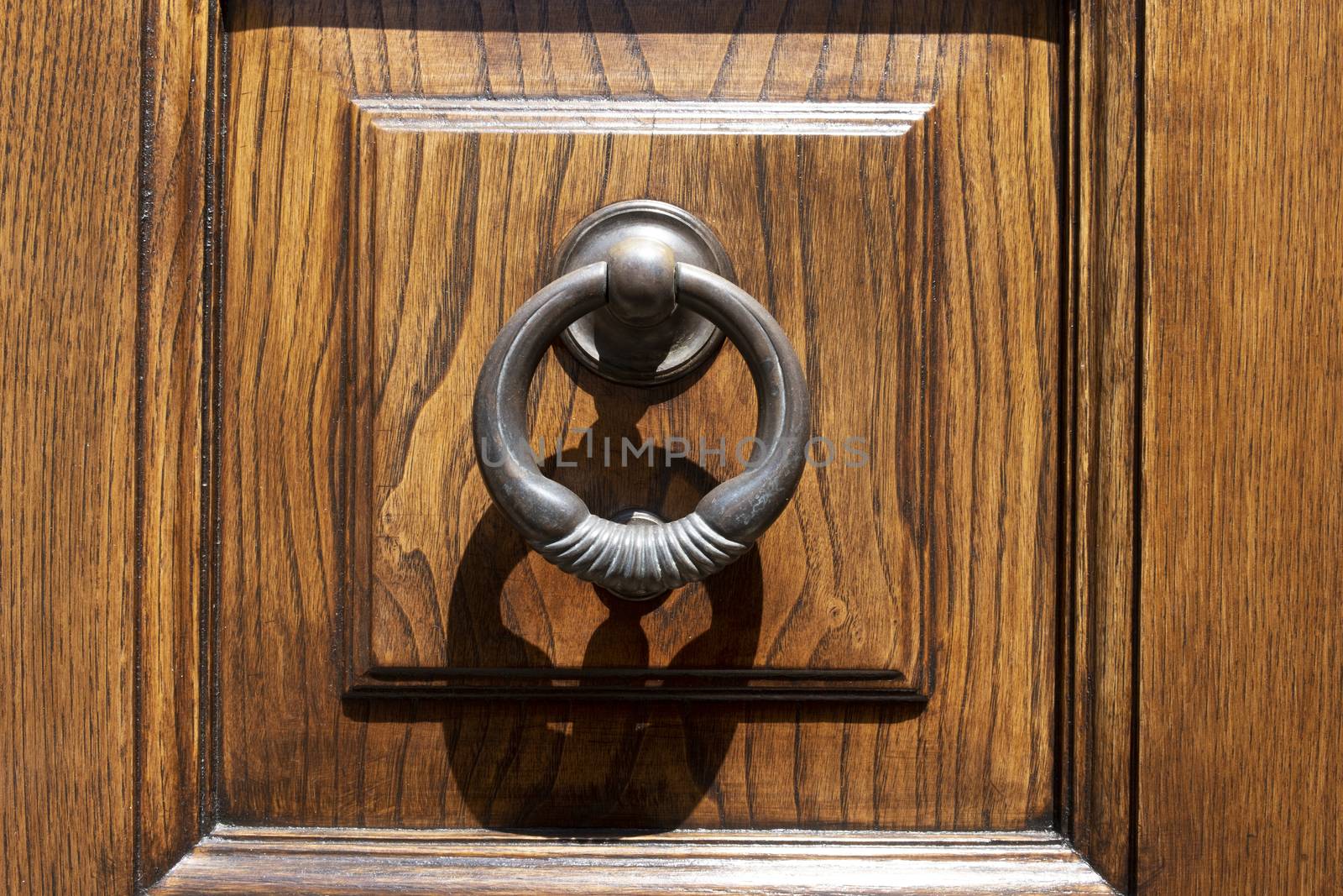 Vintage image of ancient door knocker on a wooden door. by Tjeerdkruse