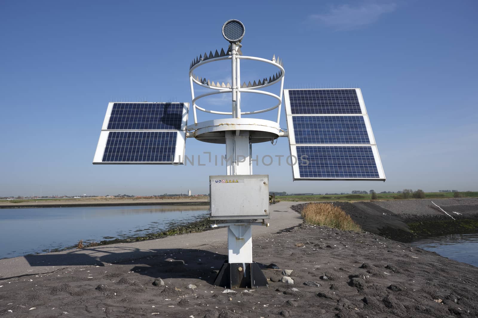 solar panel for lake harbor lighthouse energy, blue sky.