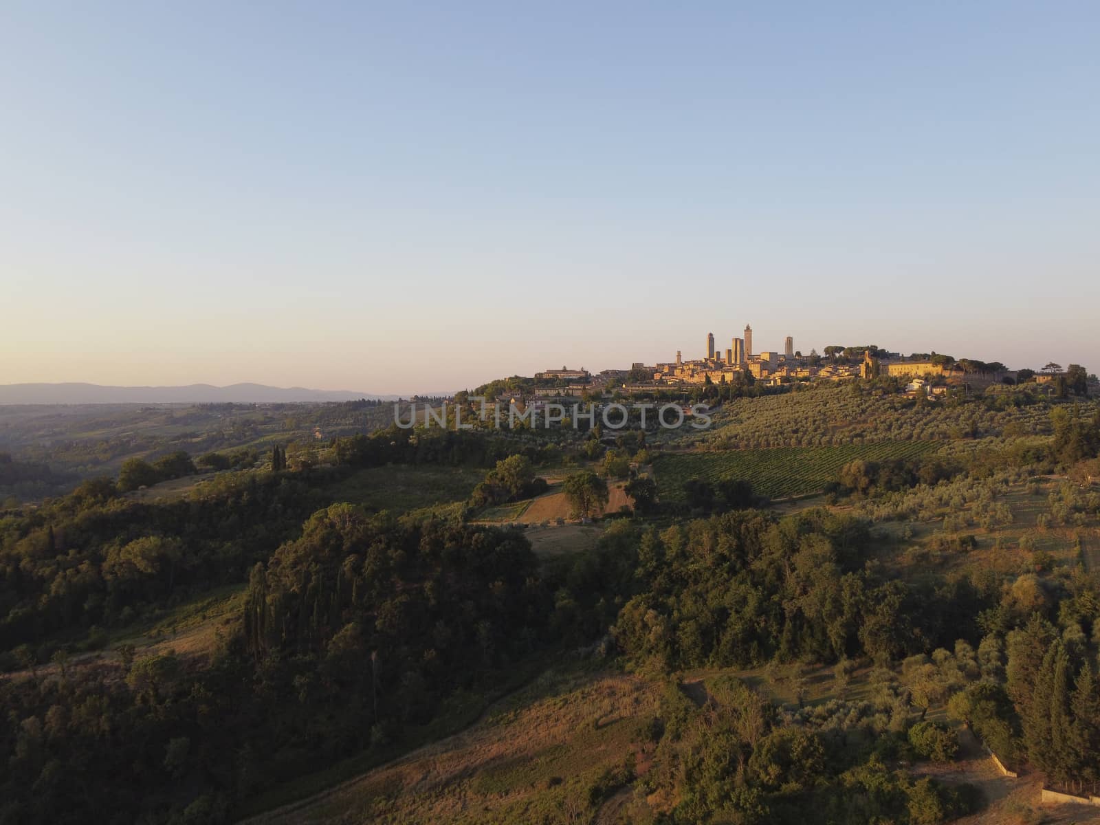 Amazing sunset panoramic view of towers of old town San Giminiano, Tuscany, Italy by Tjeerdkruse