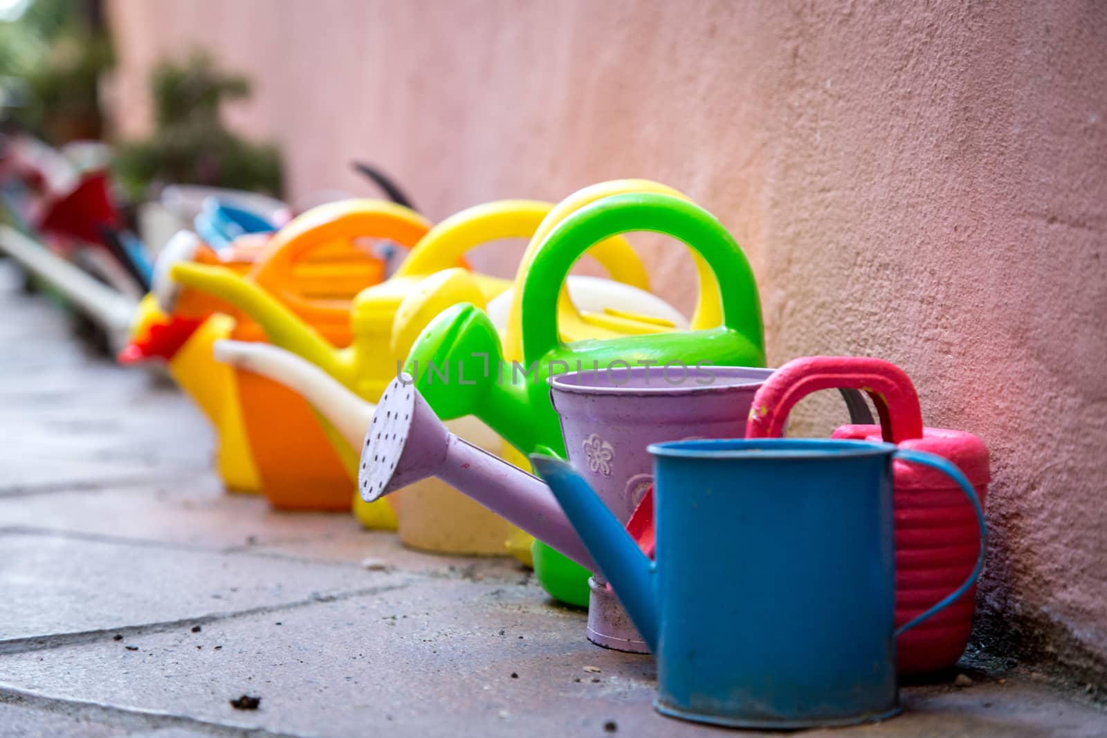 A Row of colorful watering cans for decoratiojn