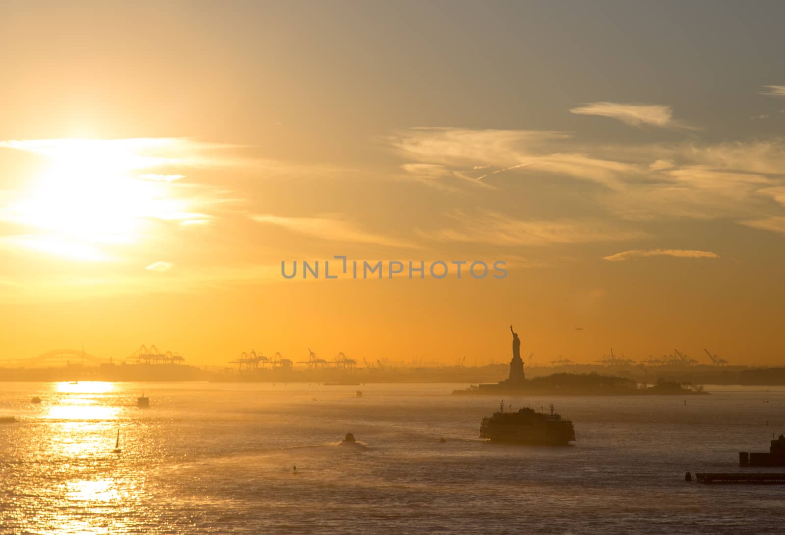 Silhouette of the Statue of Liberty in New York City during sunset