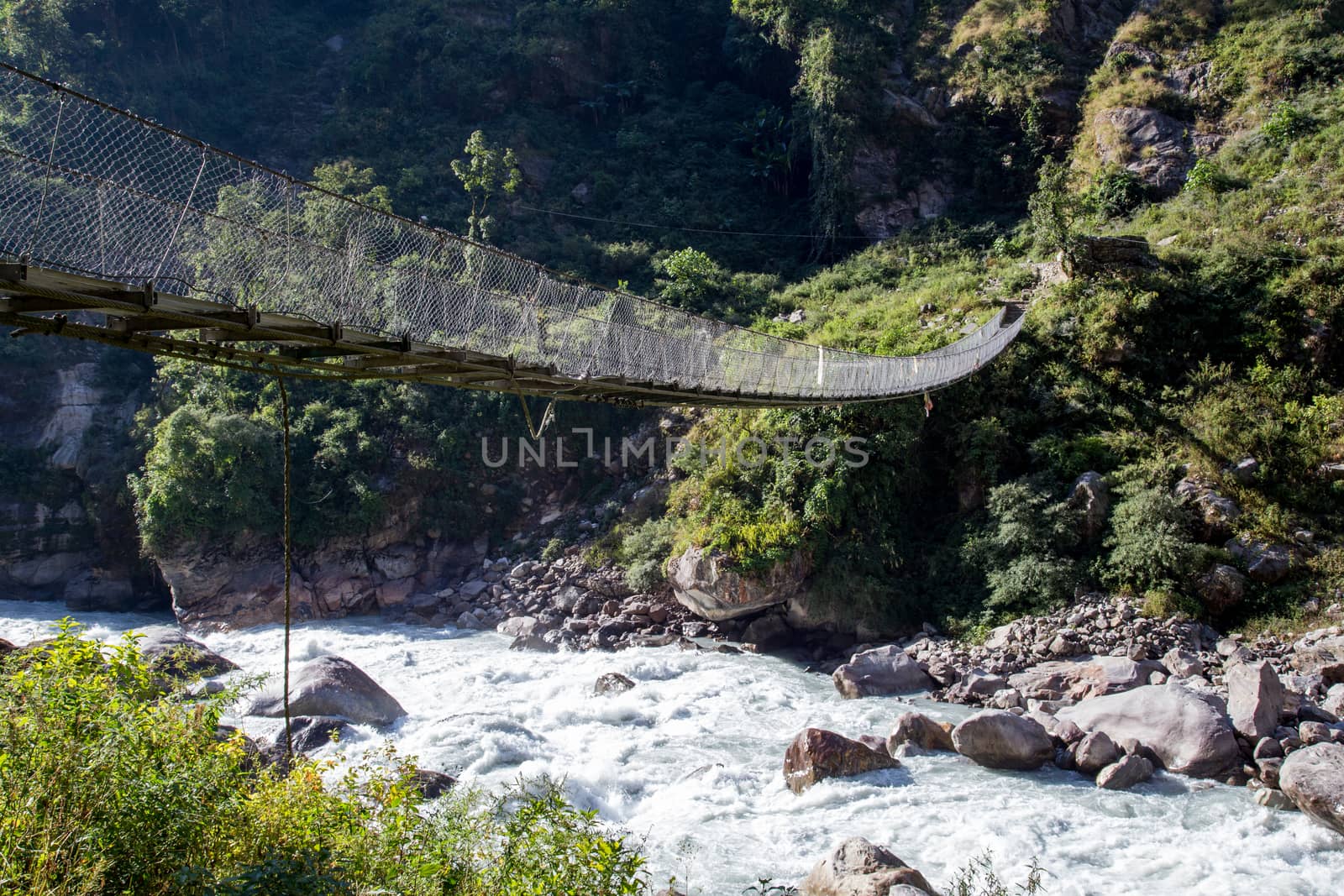 Suspension bridge crossing a river in the Annapurna region in Nepal