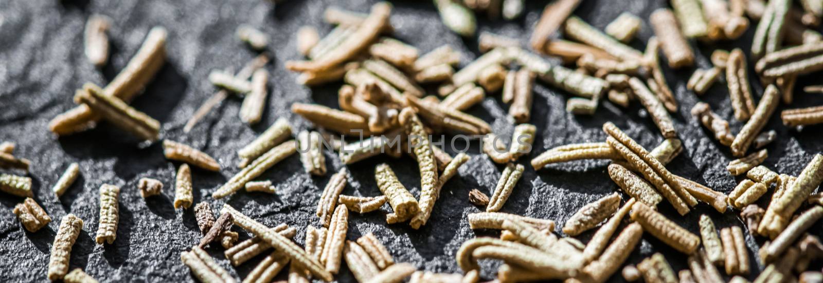 Rosemary closeup on luxury stone background as flat lay, dry food spices and recipe ingredients