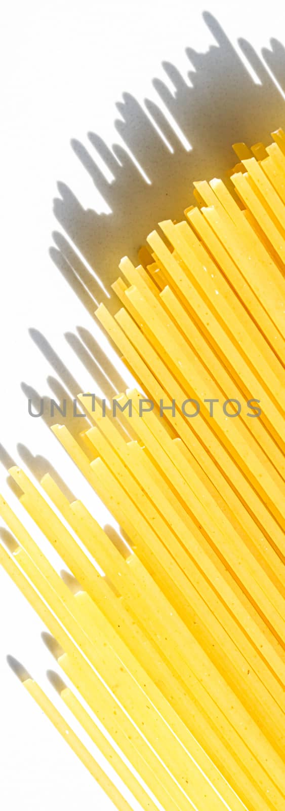 Uncooked whole grain spaghetti closeup, italian pasta as organic food ingredient, macro product and cook book recipes