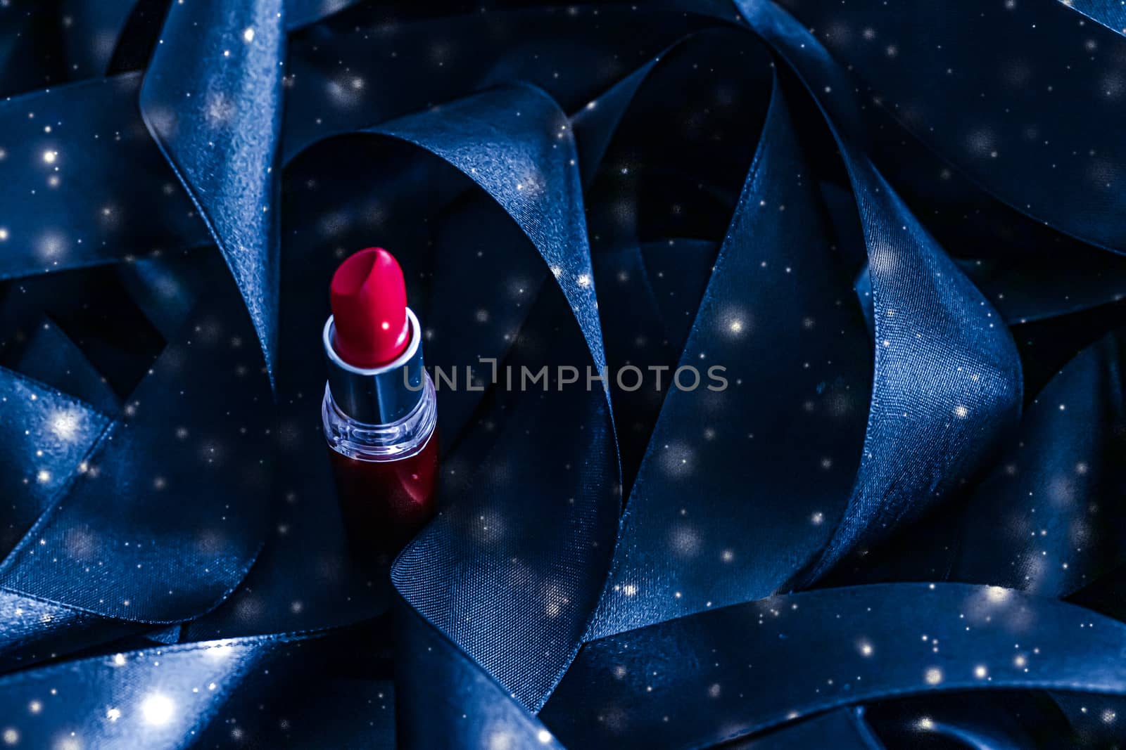 Red lipstick on blue silk and shiny glitter background, luxury make-up and beauty cosmetics