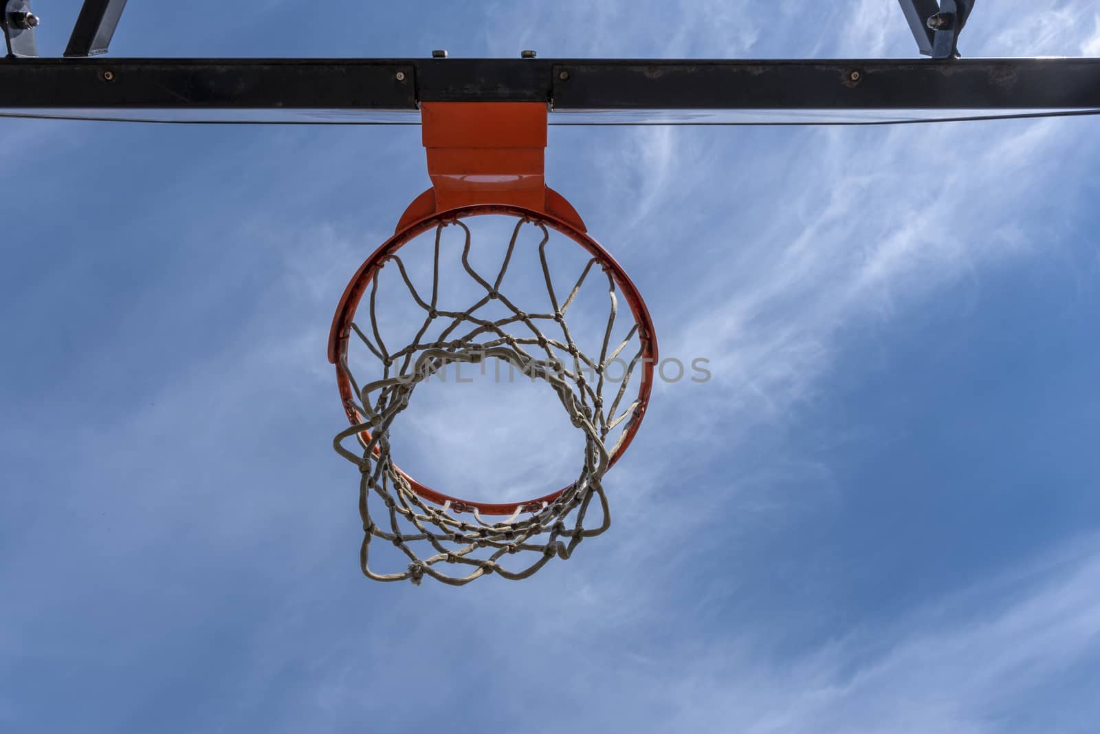 basketball hoop with a red ring against a cloudless warm summer sky by Tjeerdkruse