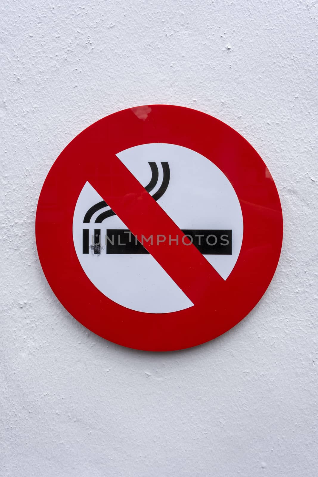No Smoking Sign on a white Concrete Wall