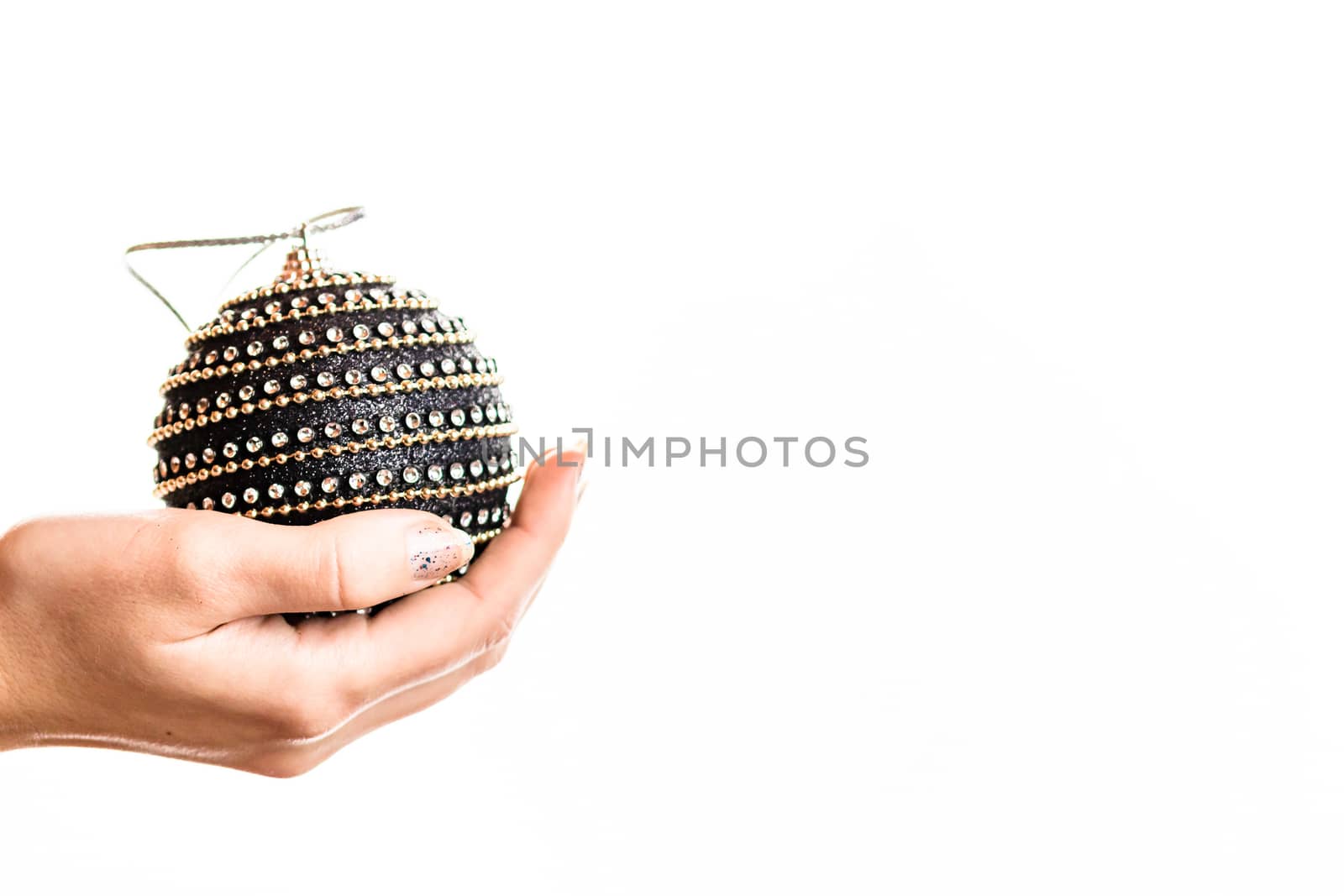 Hand holding showing giving or receiving Christmas bauble decoration isolated on white background