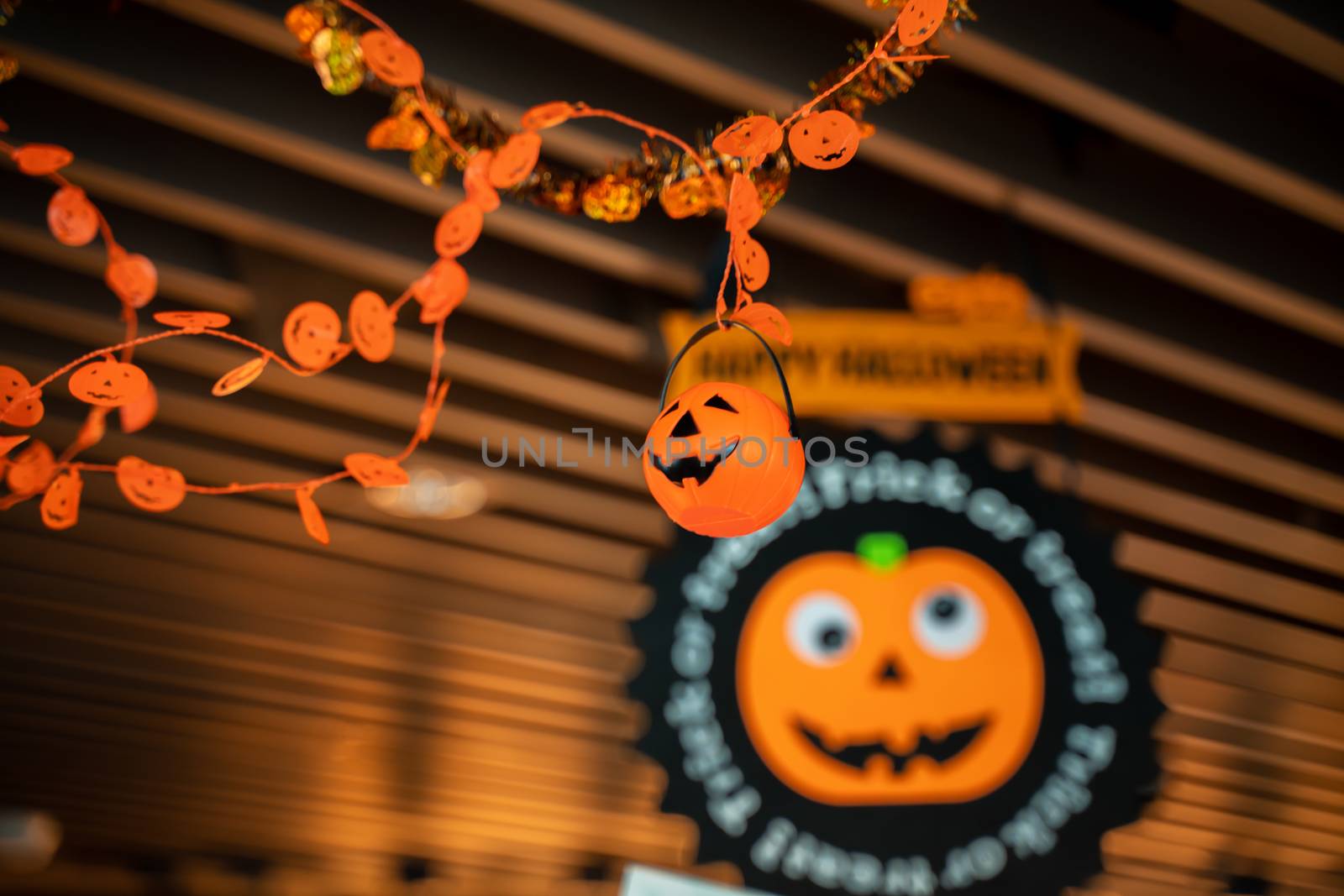 Festive Halloween cartoon decoration hanging on the ceiling of room interior, close up.