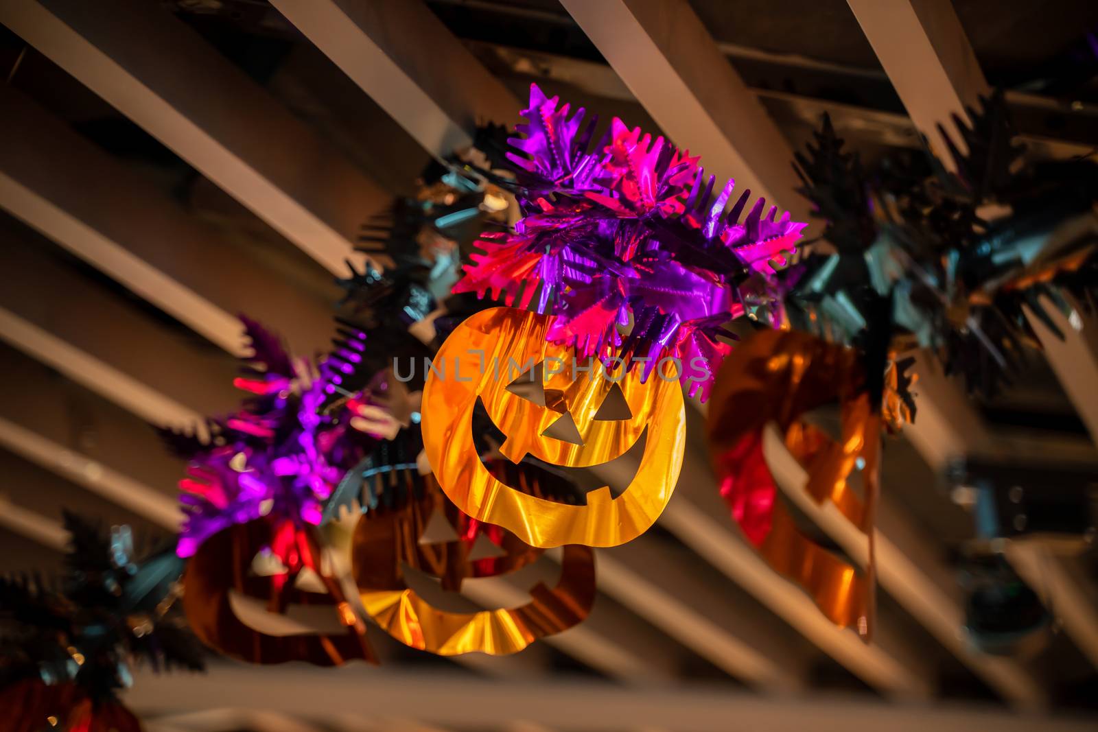 Festive Halloween cartoon decoration hanging on the ceiling of room interior, close up.