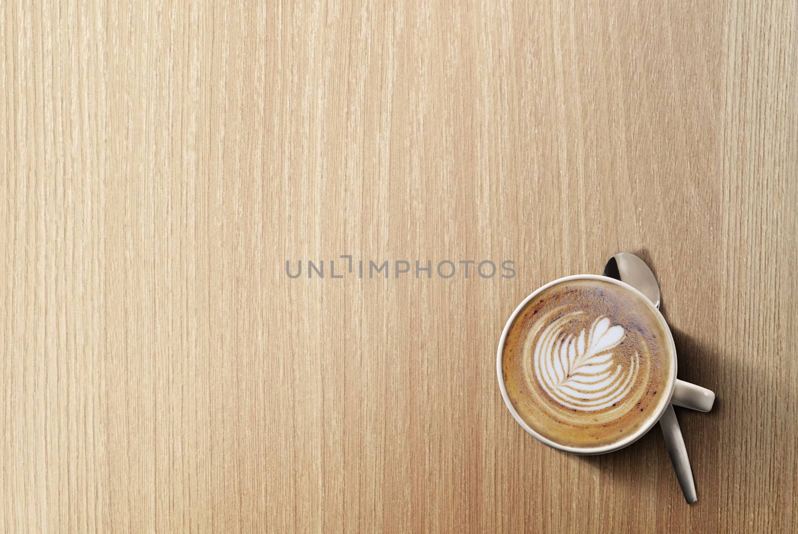 an aromatic cup of Cappuccino coffee on a wooden table by Tjeerdkruse