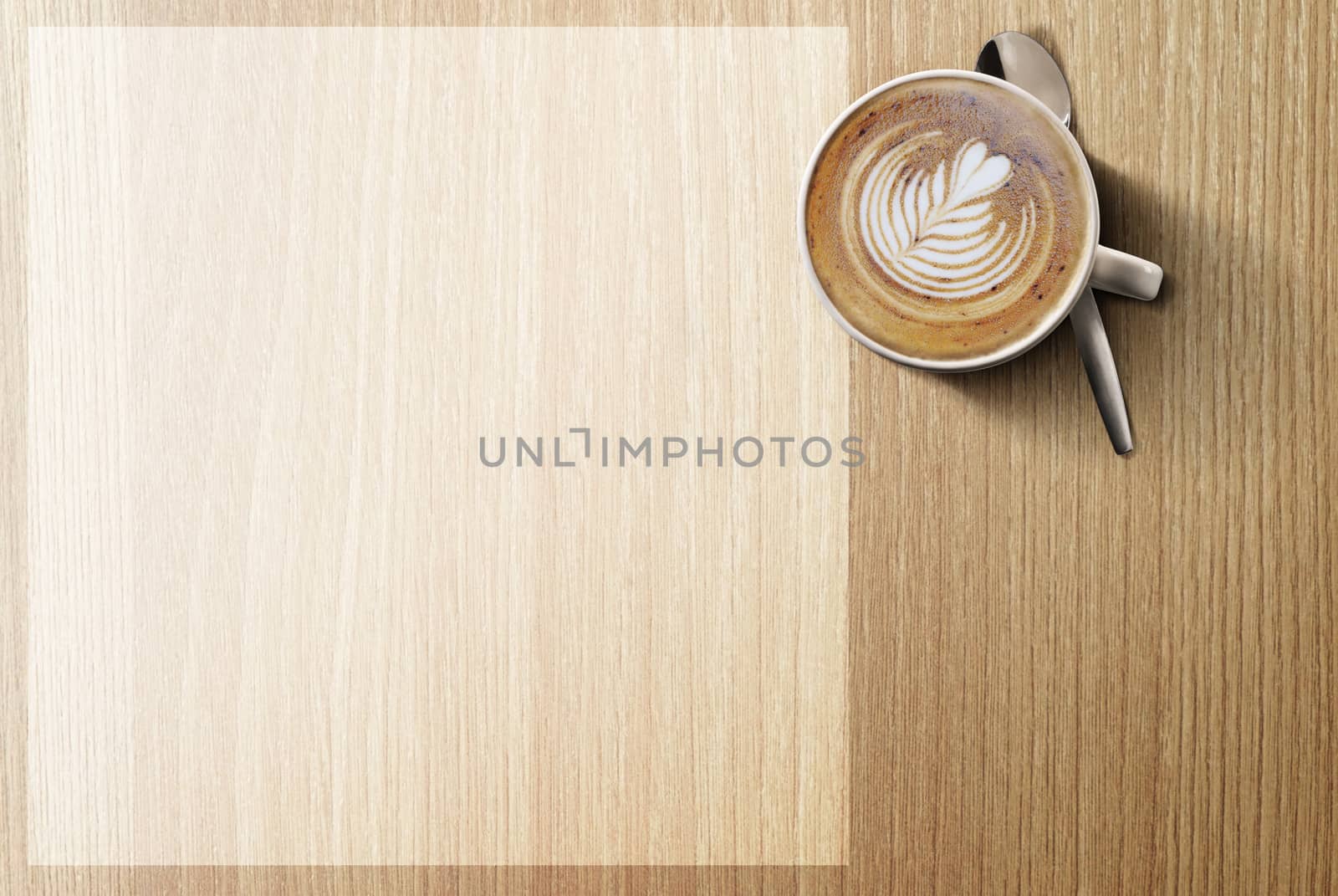 an aromatic cup of Cappuccino coffee on a wooden table with copy space