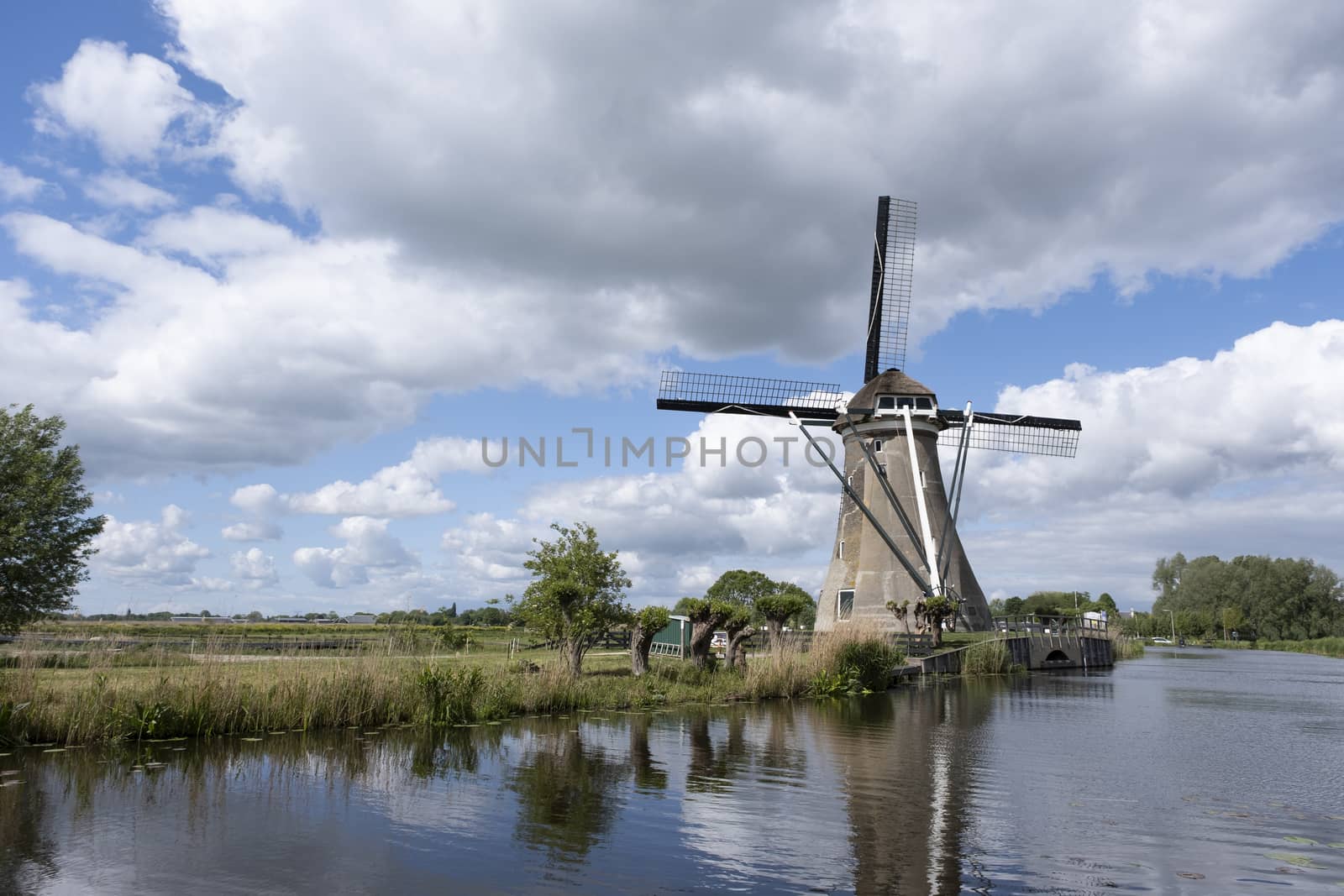 Traditional setting of the historical dutch windmills landscape, Holland by Tjeerdkruse