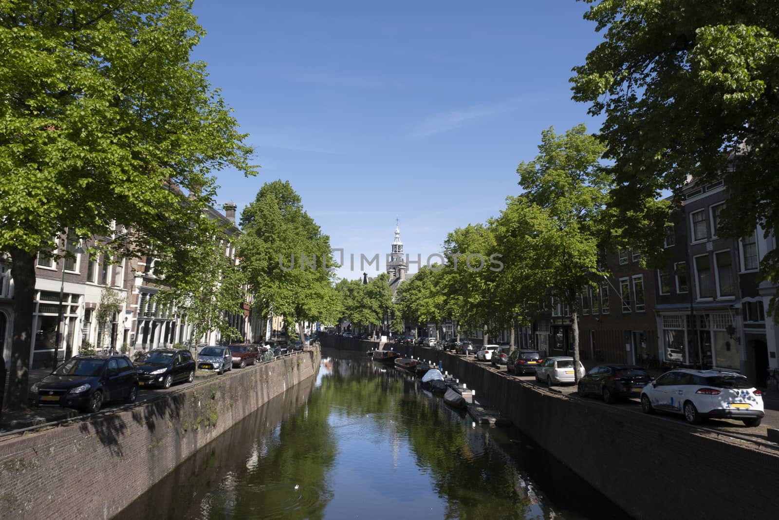 Cityscape of a canal with monumental buildings. Gouda, the Netherlands.