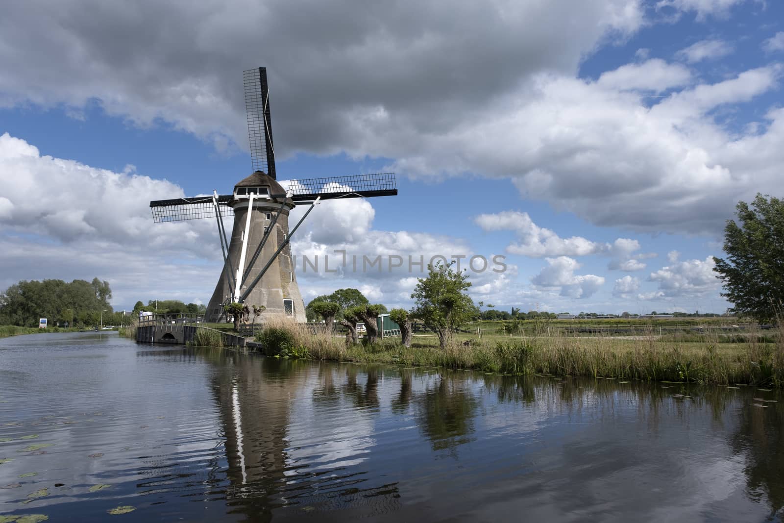 Traditional dutch windmill near the canal. Netherlands. Unesco site.