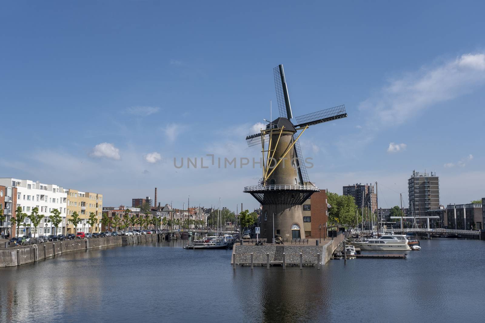 The historic Delfshaven district with a windmill in Rotterdam, The Netherlands. South Holland region. Summer sunny day