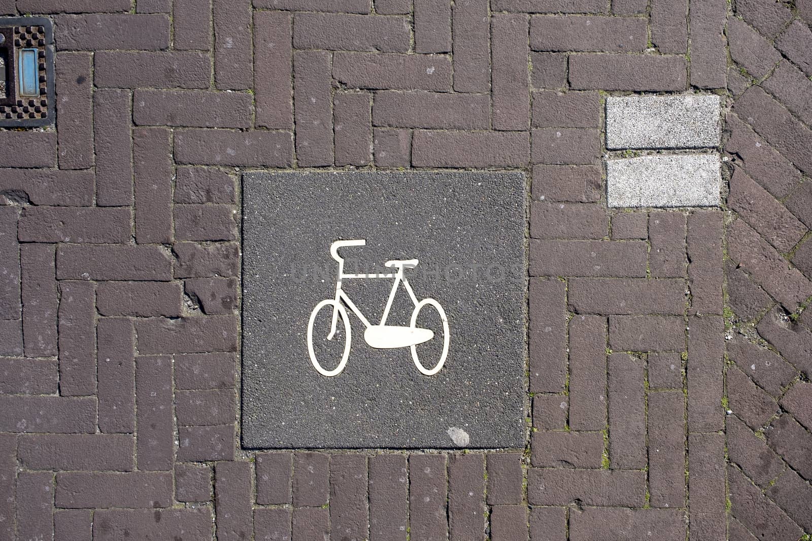 A high angle closeup shot of a bicycle sign painted on the brick by Tjeerdkruse