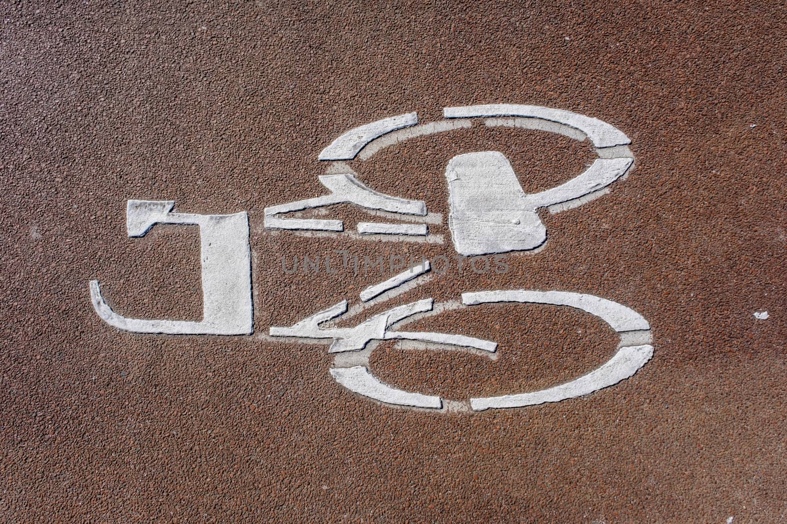 A high angle closeup shot of a bicycle sign painted on a cycle path