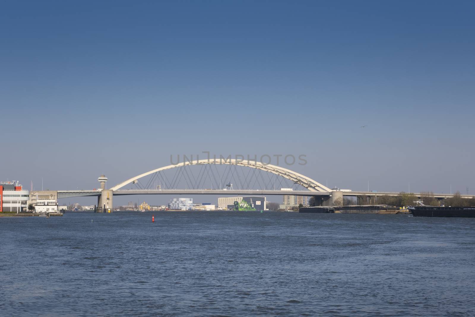 Van Brienenoord Bridge in Rotterdam over the river Nieuwe Maas seen from the north bank on the east side. The two arch bridges, part of the A16 motorway, were completed in 1965 and 1990 respectively.
