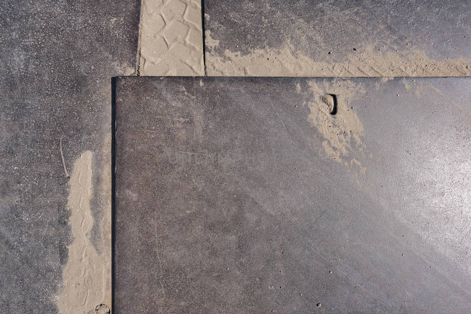 Steel plate as a drive plate or drive-over plates rusted, scratched and dirty when used on construction site as background with different designs