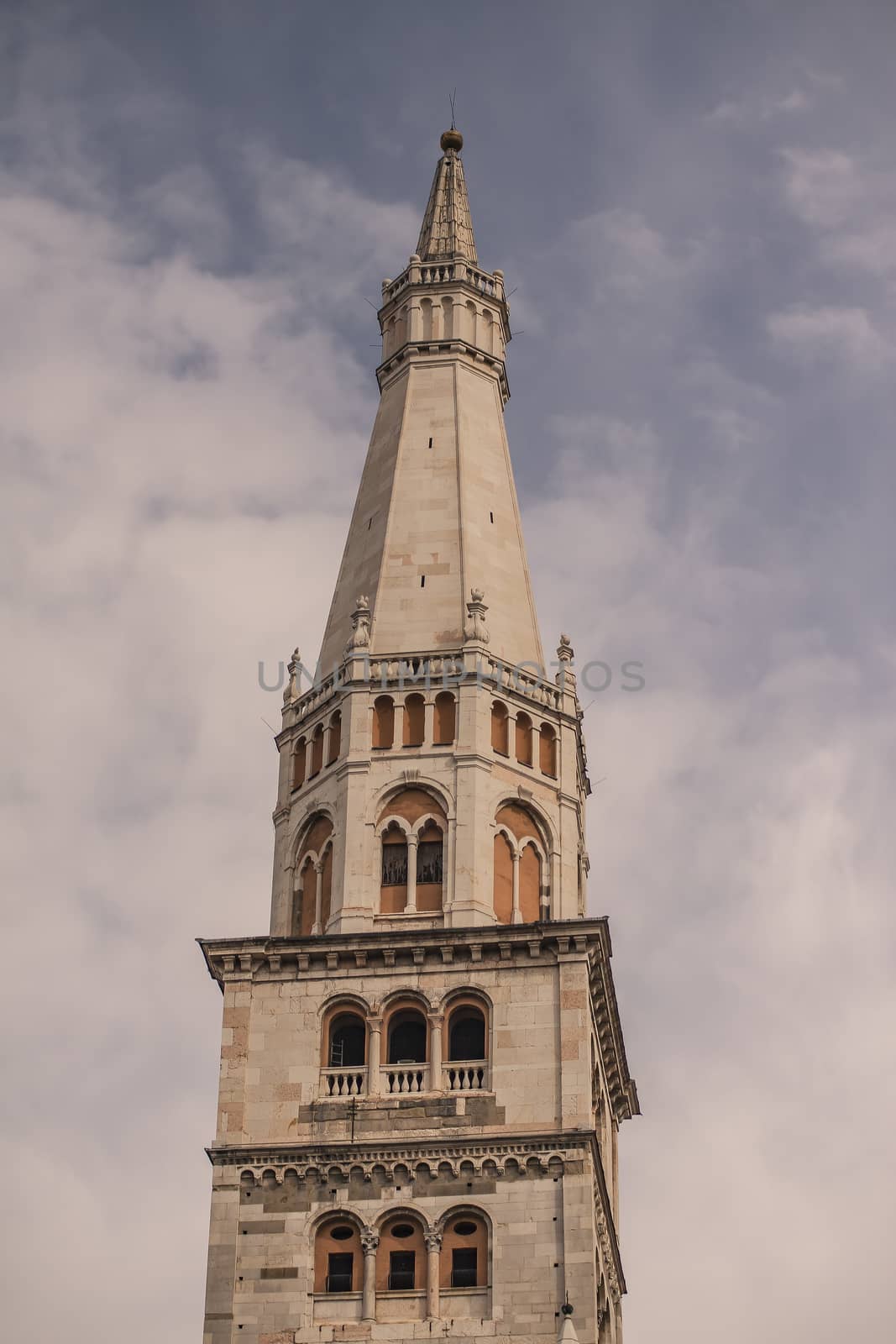 Ghirlandina ancient tower from below in Modena city, Italy