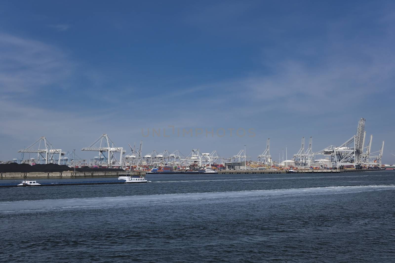 Huge cranes and ships anchored at harbor. International commerci by Tjeerdkruse