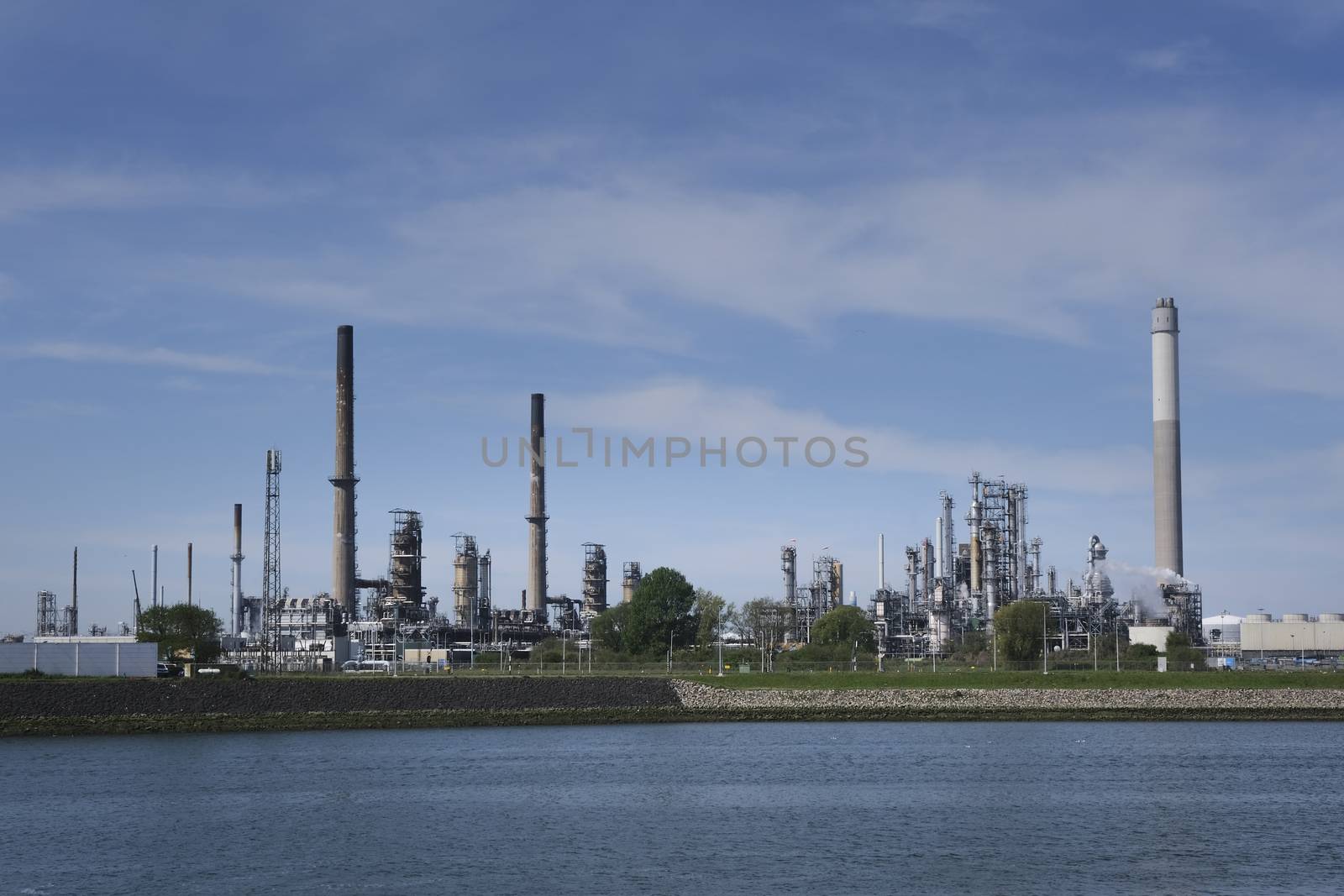 Refinery tower in petrochemical industrial plant with cloudy sky, Refinery factory oil storage tank and pipeline steel