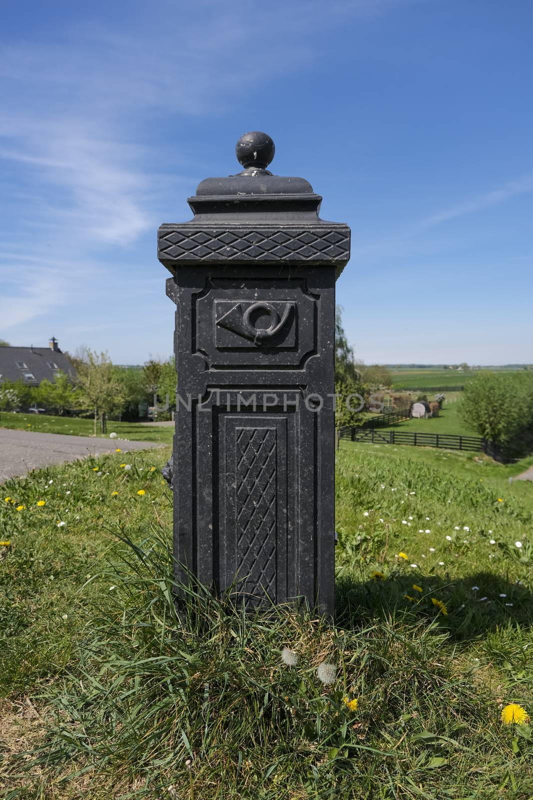 old country antique rusted mailbox in farmer's field with house  by Tjeerdkruse