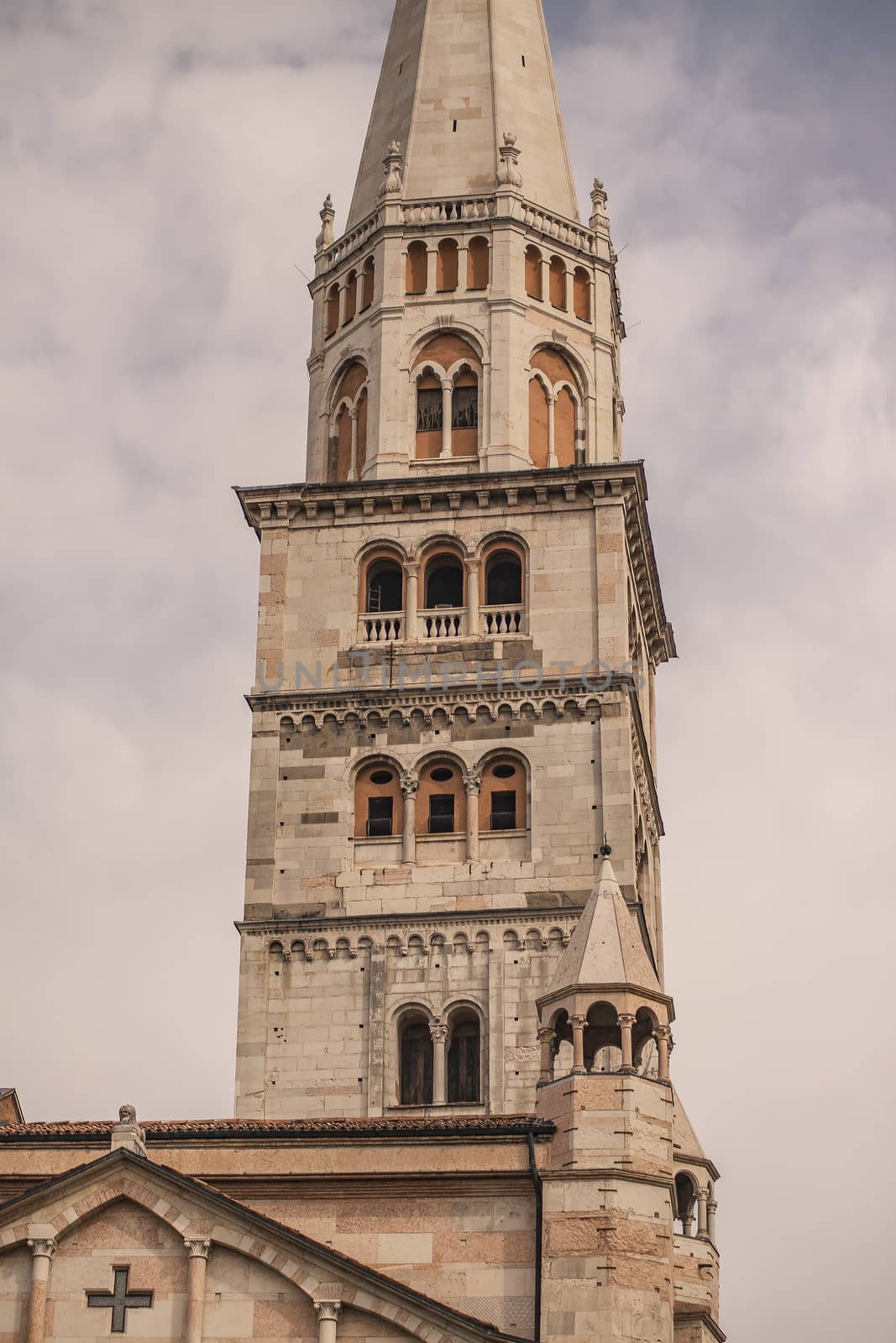 Ghirlandina ancient tower from below in Modena city, Italy