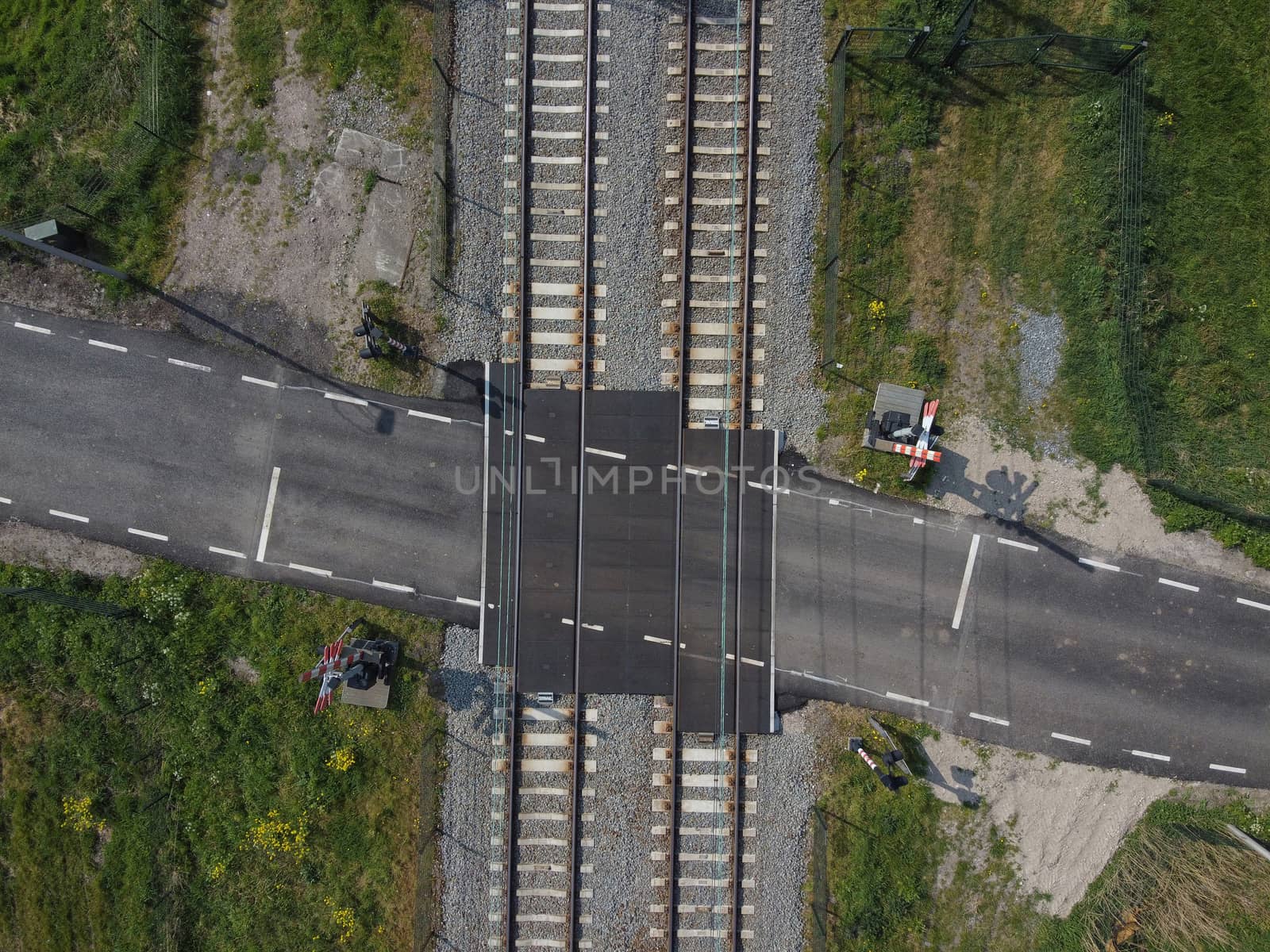 Railroad crossing and Train Tracks from Above. Aerial view