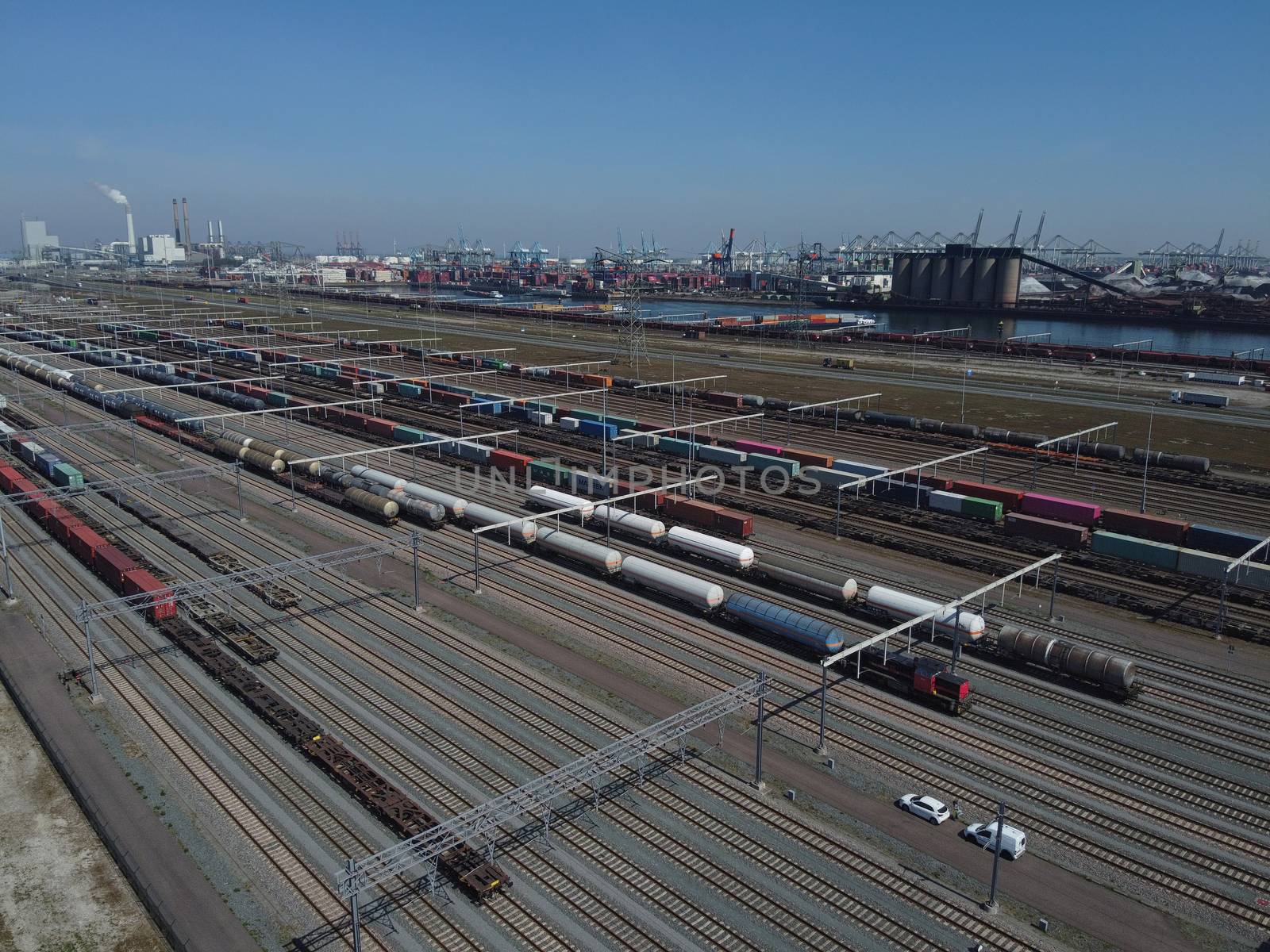 Aerial bird view photo of railroad container terminal with train by Tjeerdkruse