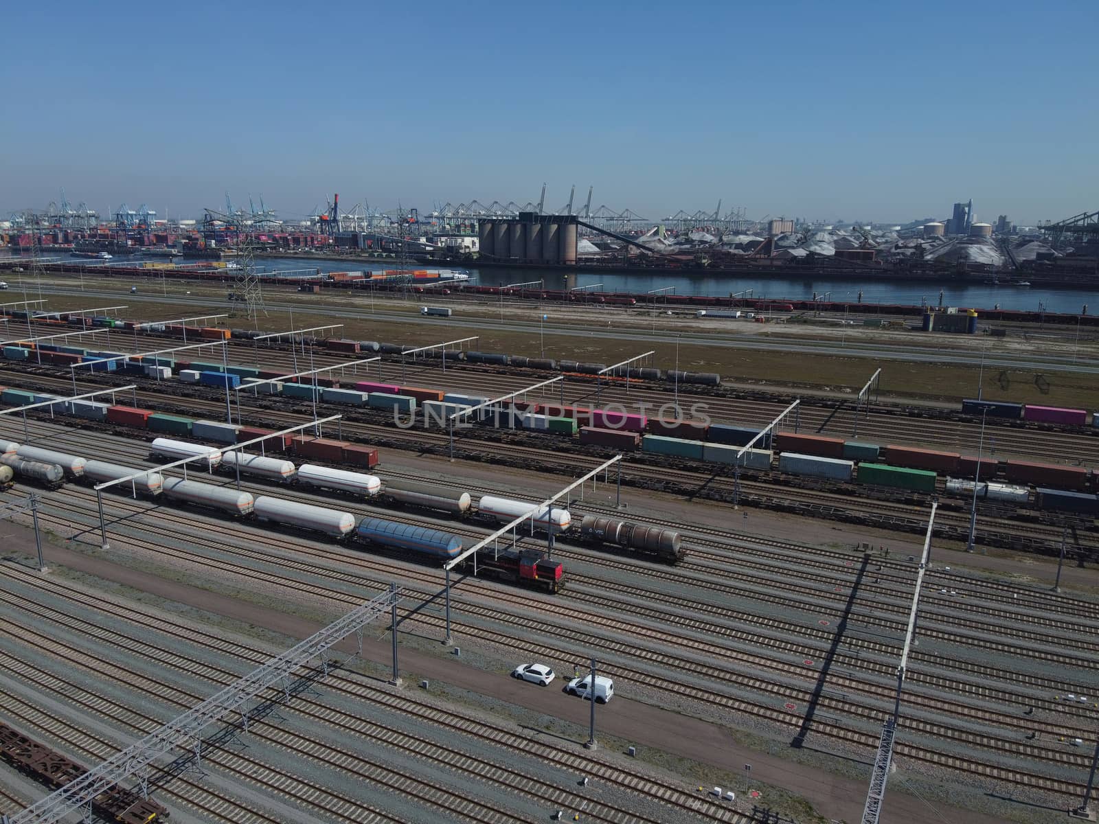 Aerial bird view photo of railroad container terminal with train by Tjeerdkruse