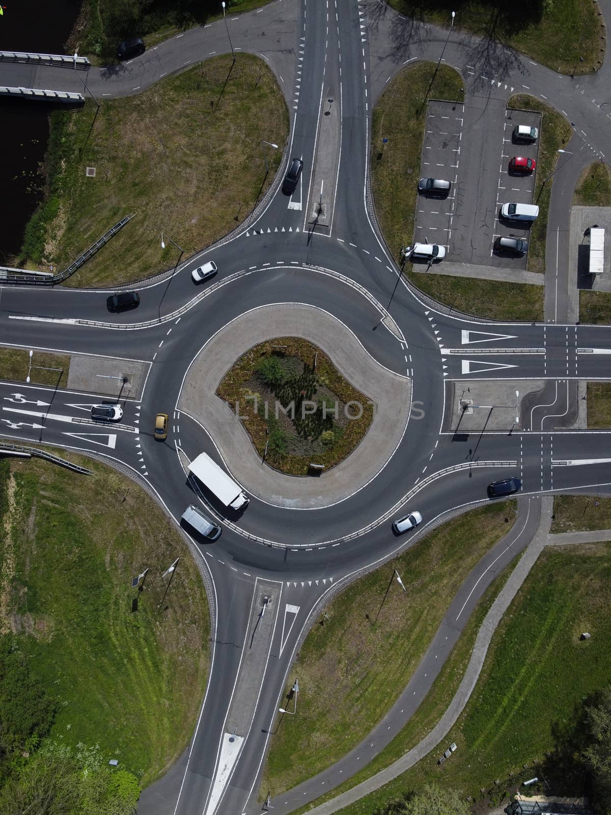 Aerial top down view of a traffic roundabout on a main road in a by Tjeerdkruse