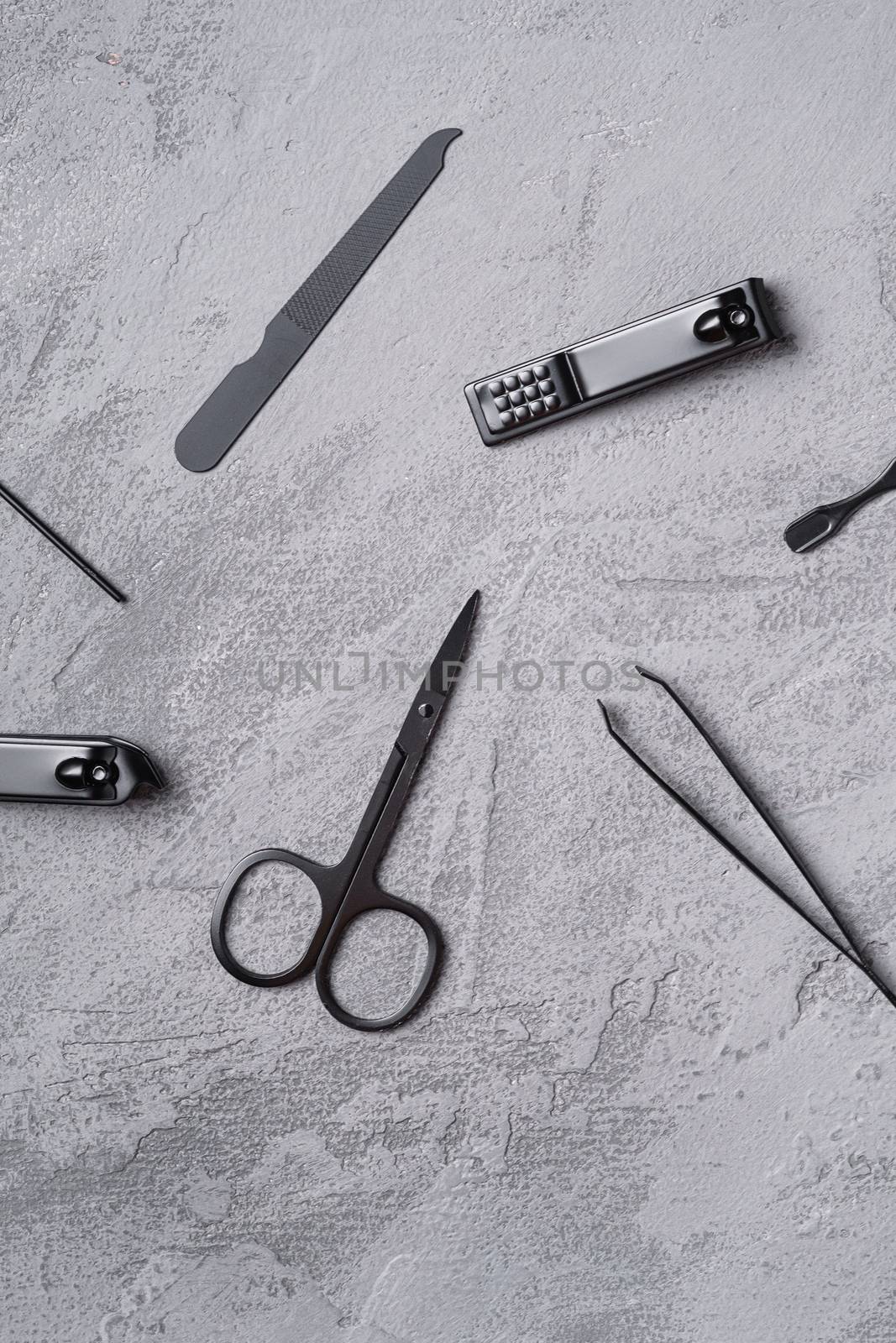 Set of manicure, pedicure tools and accessories, stone concrete background, top view