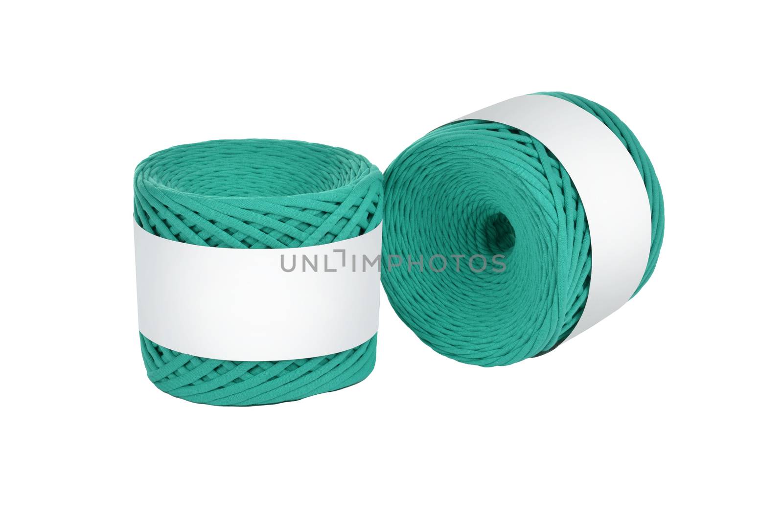 Two skeins of green color elastic knitted cotton yarn for crochet. Roll with mockup label layout on white background. Use for handwork, creating wicker baskets and home accessories.