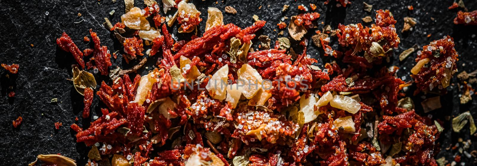 Dried tomato and chili pepper closeup on luxury stone background as flat lay, dry food spices and recipe ingredients