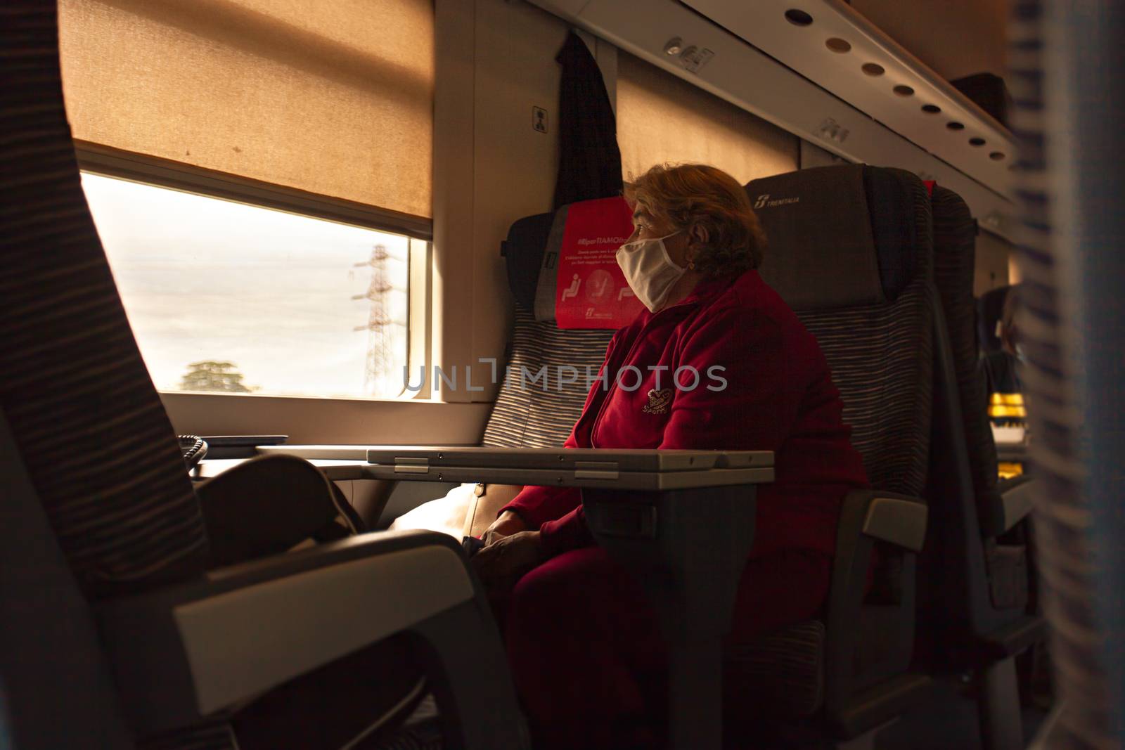 MODENA, ITALY 1 OCTOBER 2020: Old woman wears medical mask in train during Covid period