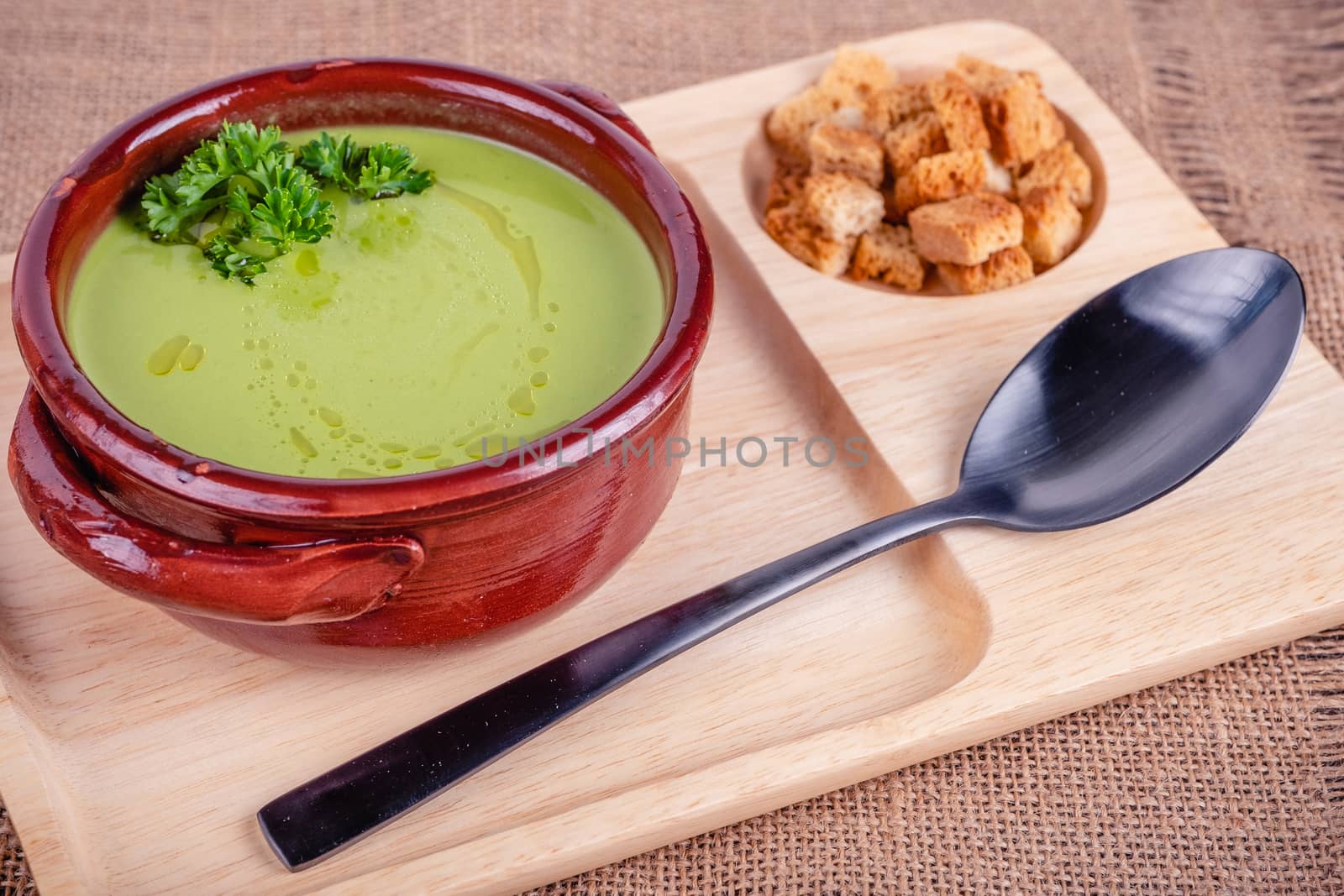 Fresh asparagus creamy soup and ingredients on a wooden table. by Fischeron