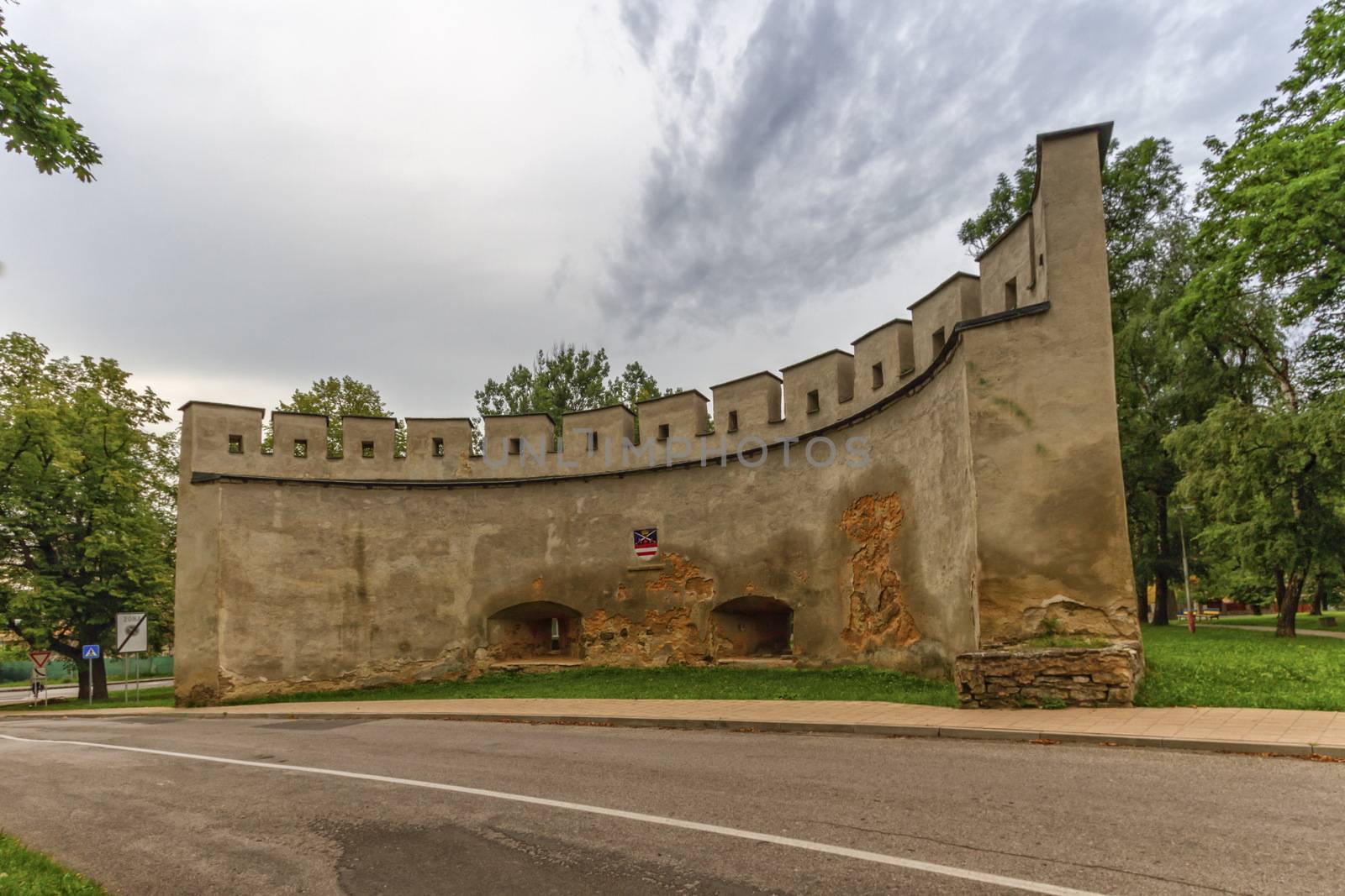 Historical wall among the trees in Kezmarok, Slovakia by Elenaphotos21