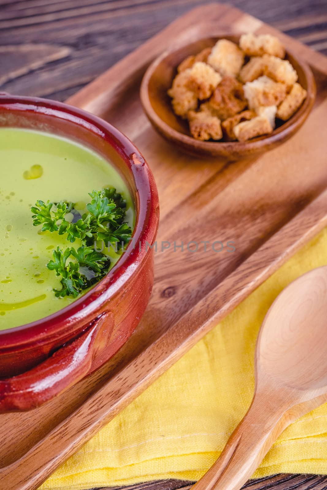 Fresh asparagus creamy soup and ingredients on a wooden table. by Fischeron